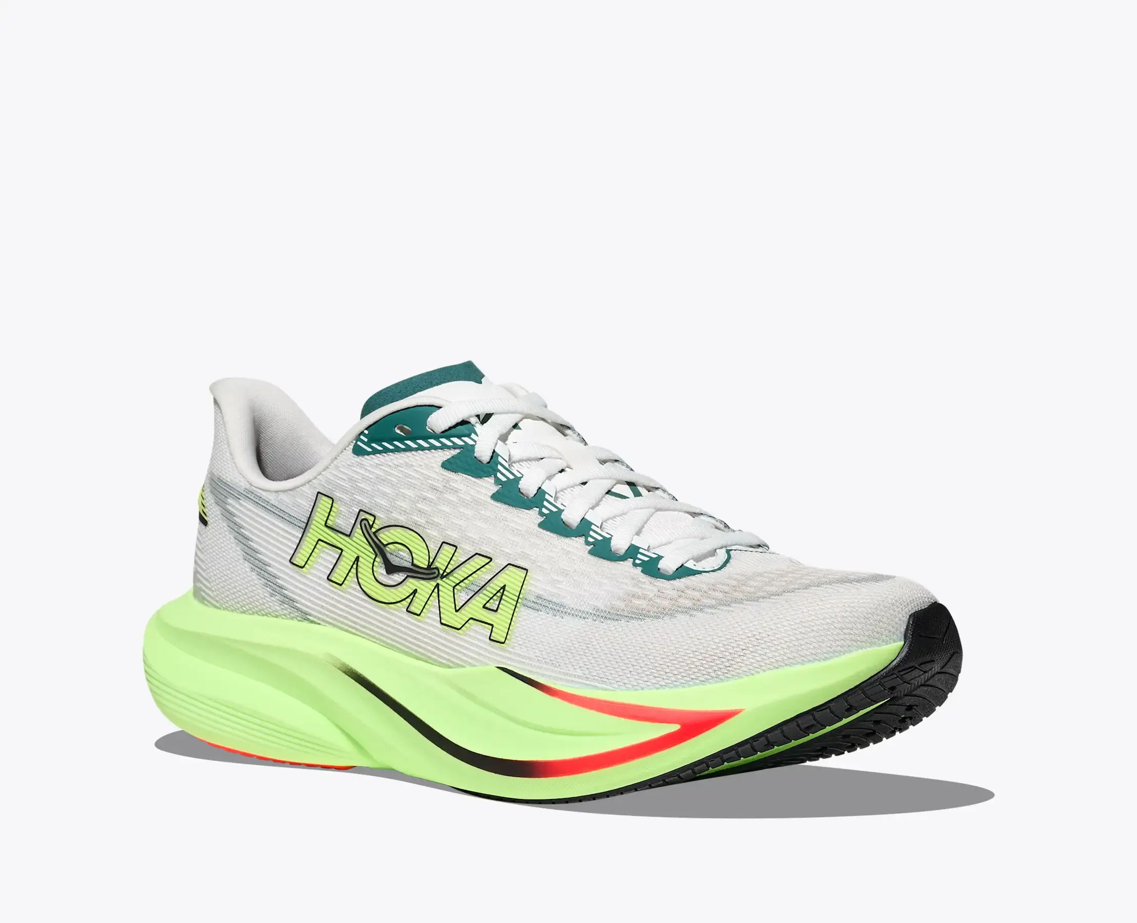 A close-up of a colorful running shoe with a light gray upper, green accents, and a neon yellow midsole, featuring the word "TICKA" on the side.
