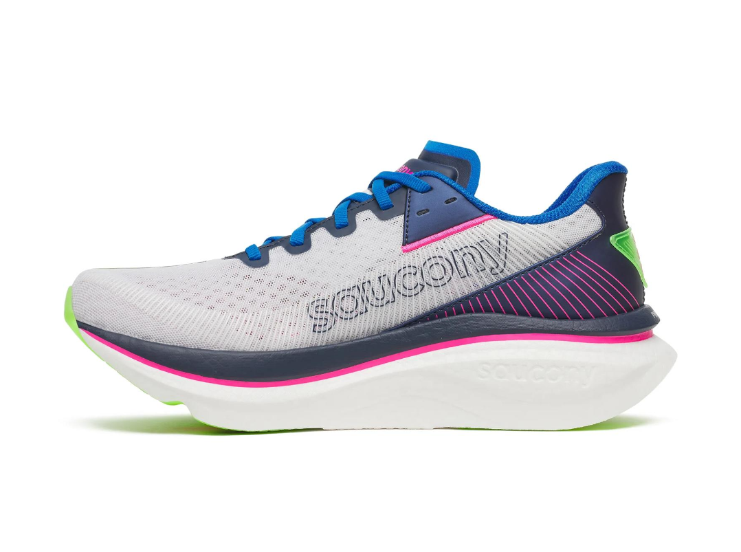 A Saucony running shoe with a white mesh upper, blue laces, and pink and green accents.