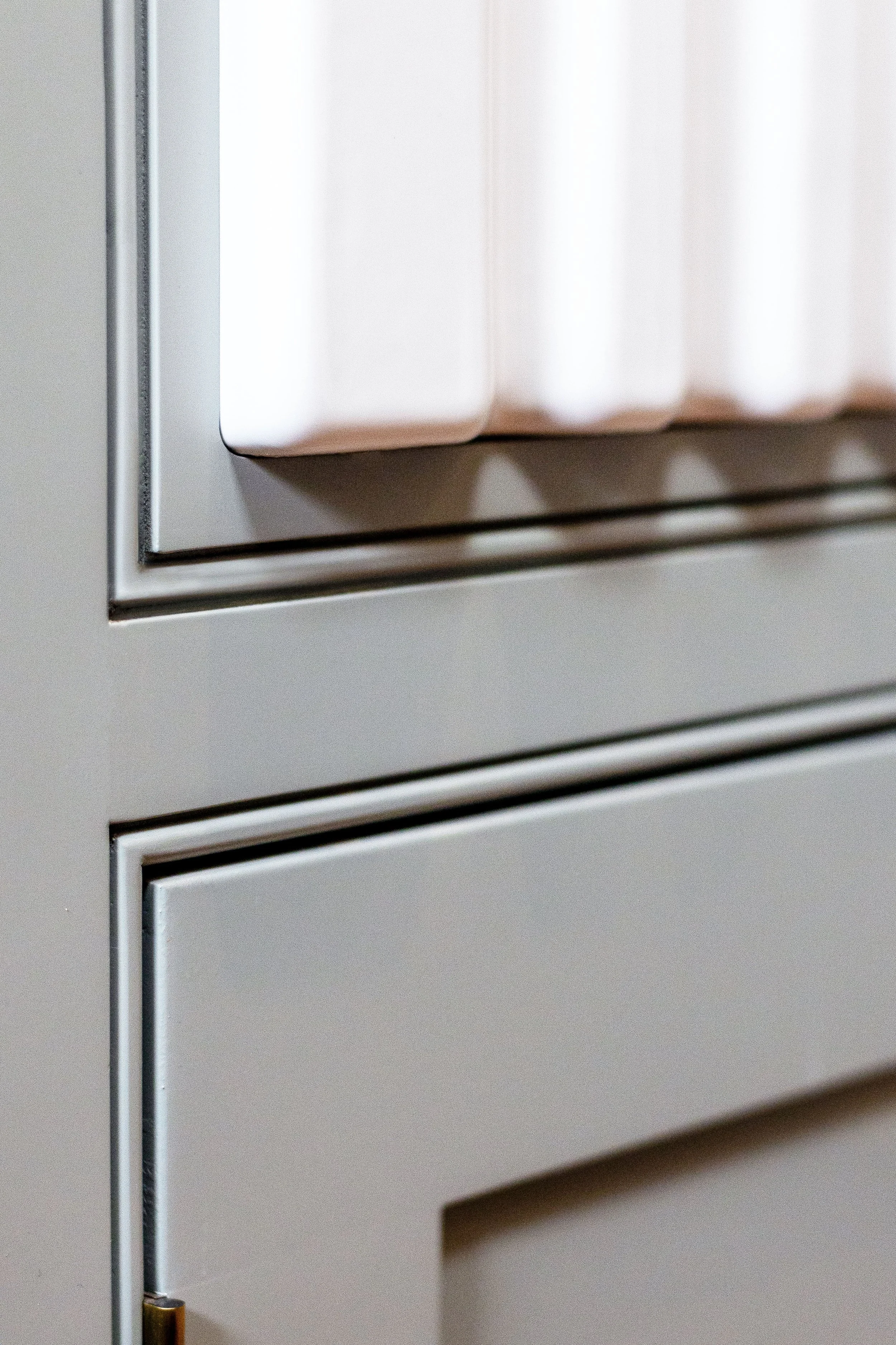 Close up of a green sage handmade kitchen unit.