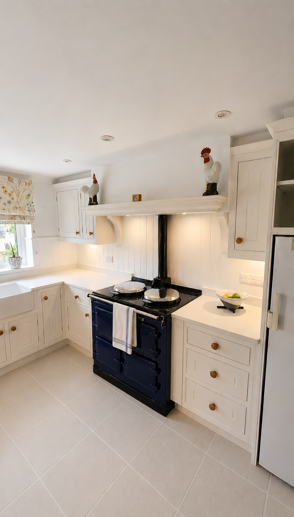 A beautifully handcrafted kitchen with a navy blue AGA oven.
