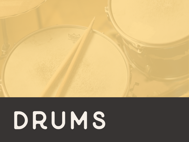 Close-up of a drum set, including drums and drumsticks.