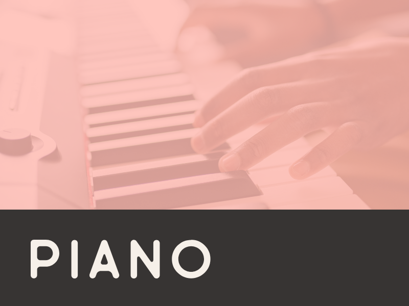 Close-up of a person's hand playing piano keys with the word 'PIANO' written below.