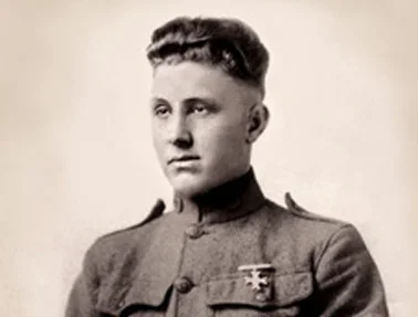 Black and white portrait of a young woman in a military uniform with short, styled hair.