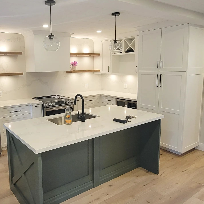 Modern kitchen with white cabinetry, a gray kitchen island, open shelves with decorations, and pendant lighting.