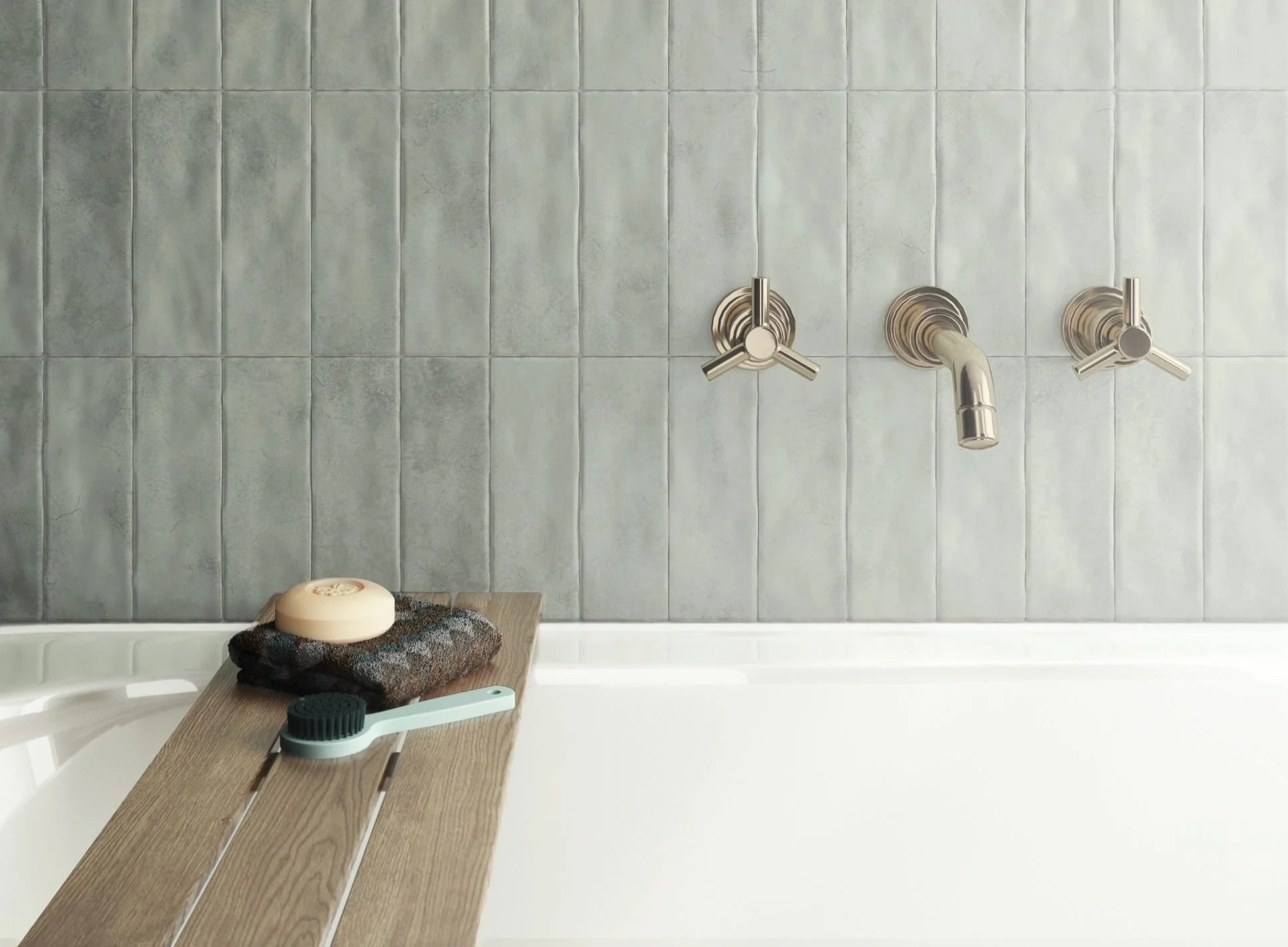 Bathroom wall with gray tiles, stainless steel faucet, soap dish, and wooden shelf holding soap, towel, and toiletries.