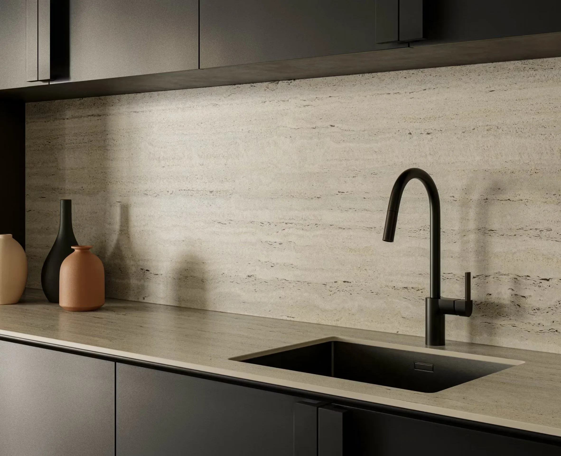 Modern kitchen with beige countertop, black faucet, and decorative vases on the left.