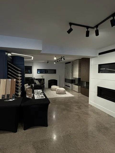 Interior of a modern furniture showroom with display samples, seating area, and contemporary design elements.