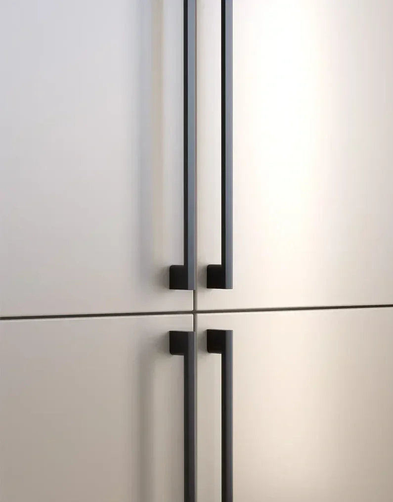 Close-up of white cabinet doors with black vertical handles