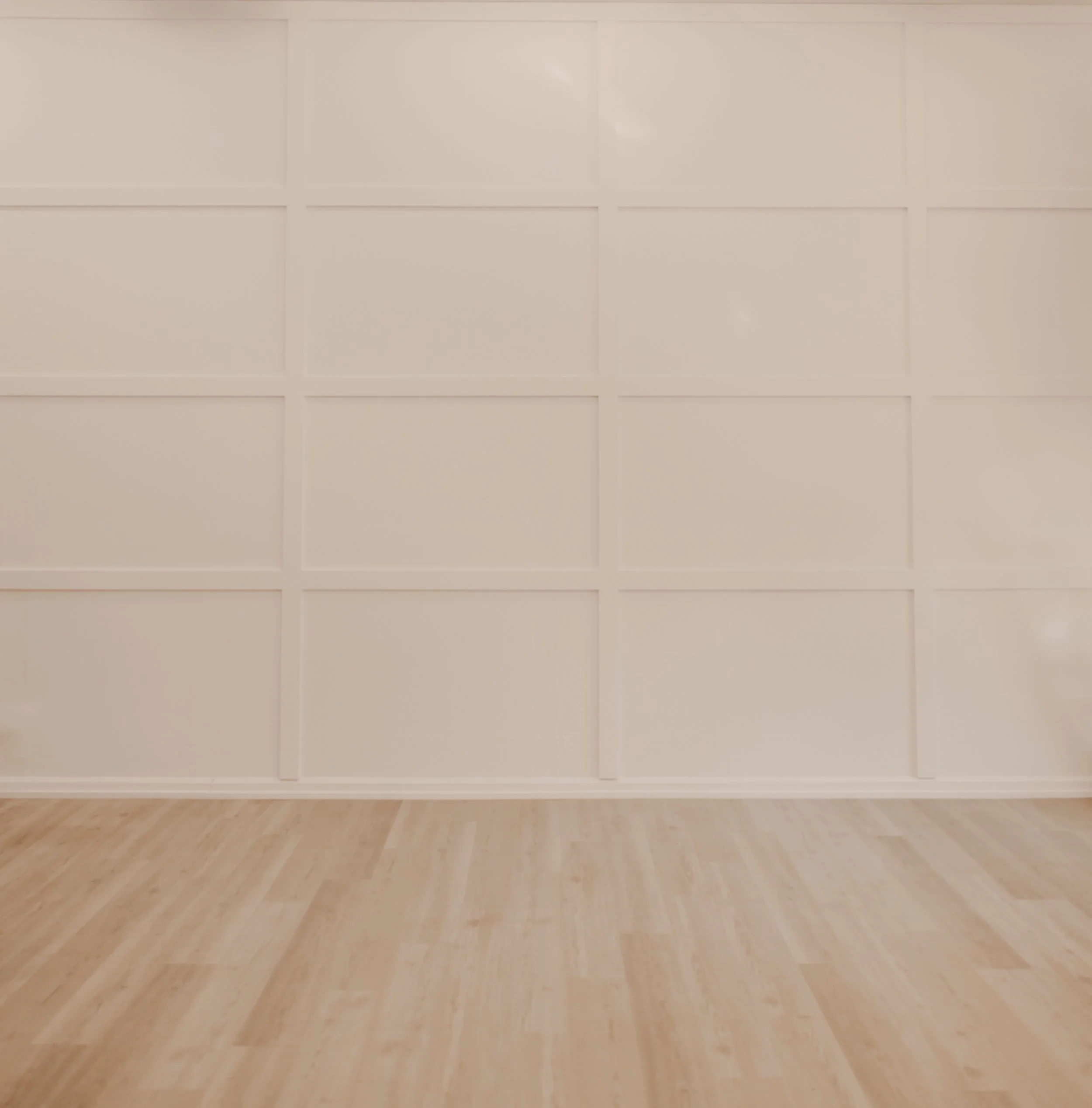 Empty art gallery with wooden flooring and beige walls divided into rectangular panels.