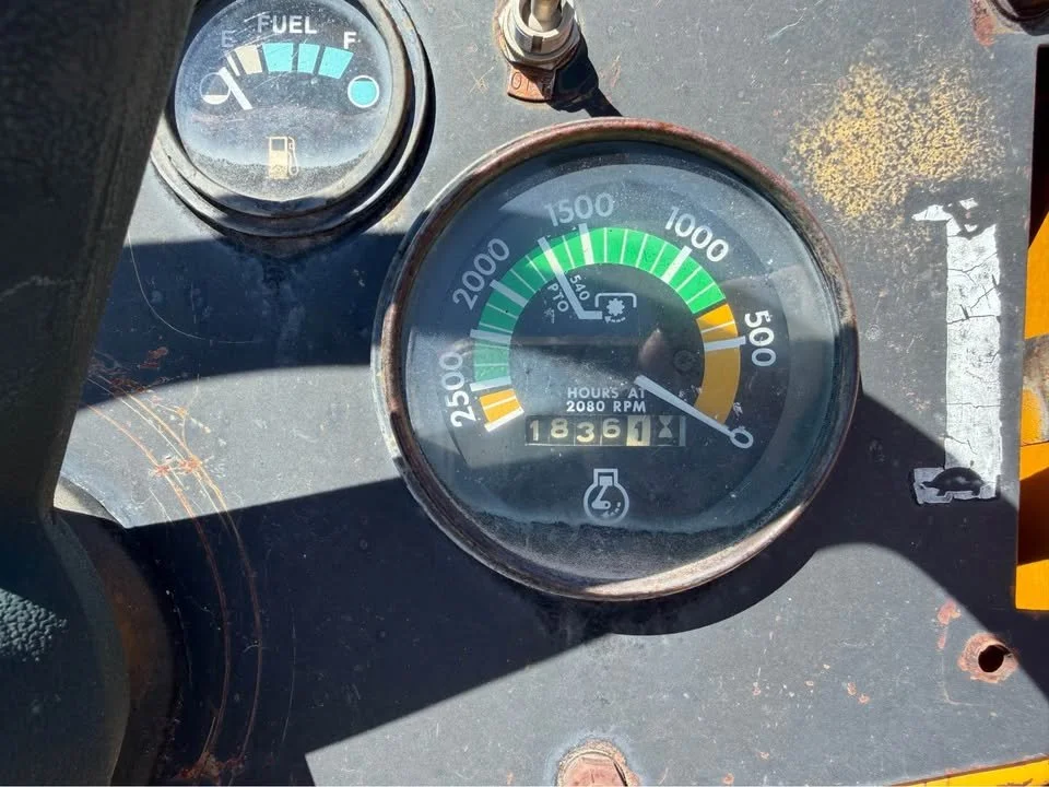 Close-up of a vintage vehicle dashboard showing a fuel gauge at empty, a tachometer at 2080 RPM, and an odometer reading 18361 miles.