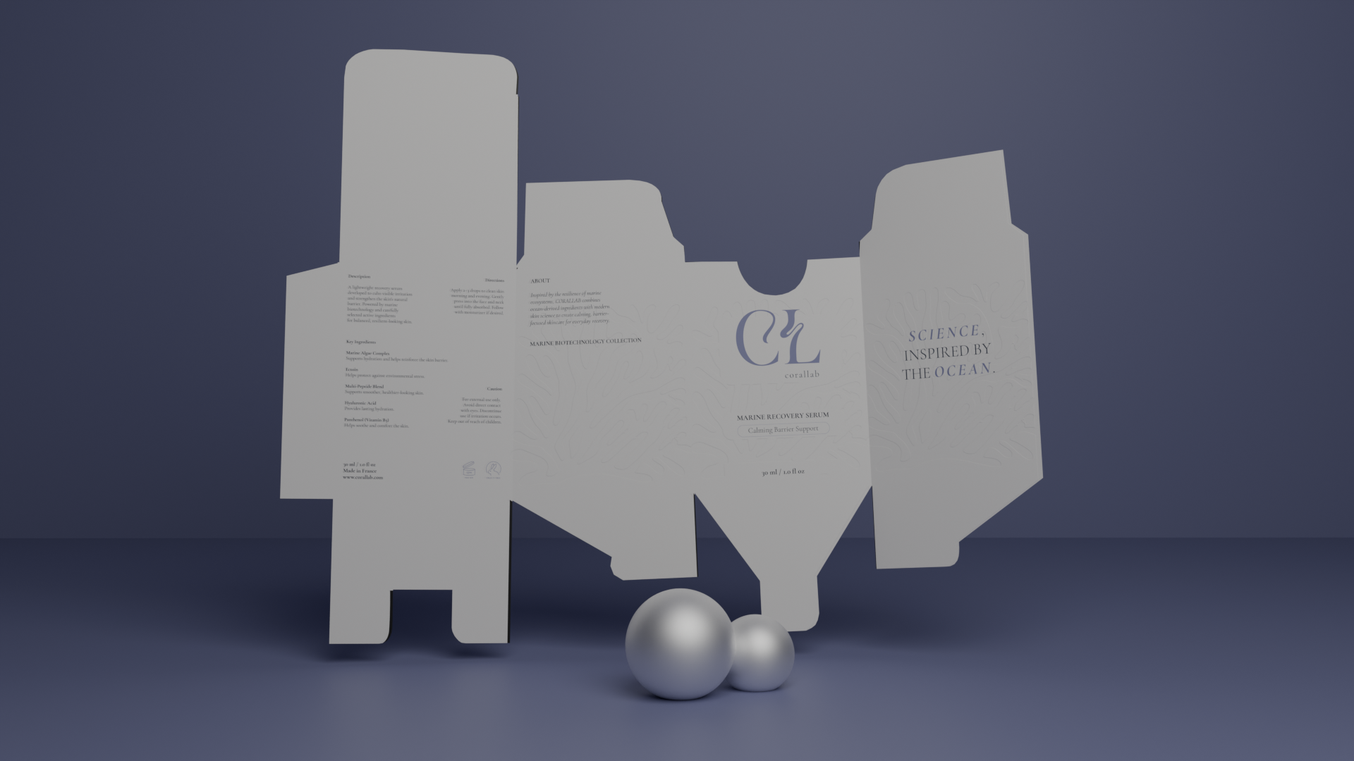 Open white cardboard box with text and logos inside, placed against a dark gray background, with three metallic silver balls at the bottom.
