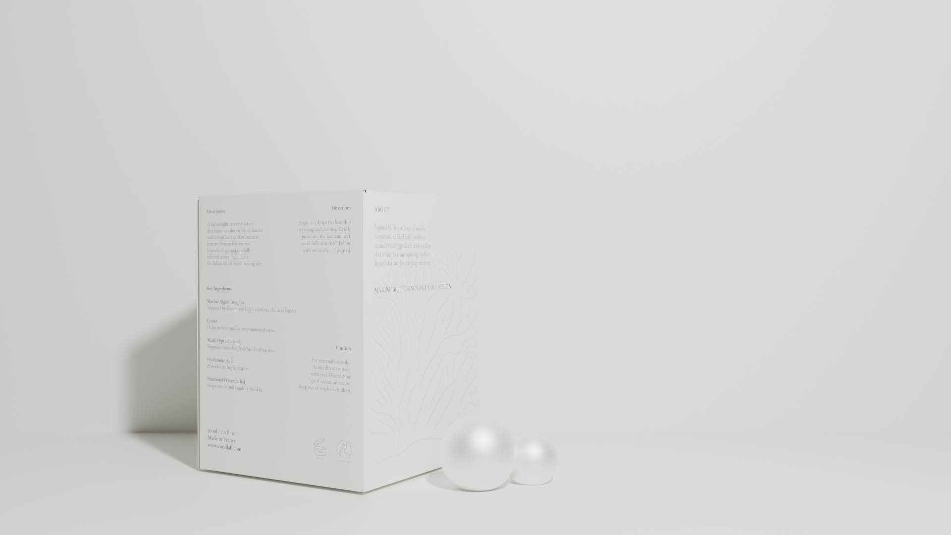 A white box labeled Marine Biotechnology Collection, standing upright on a light surface with two white spheres on the right, in front of a plain white wall.