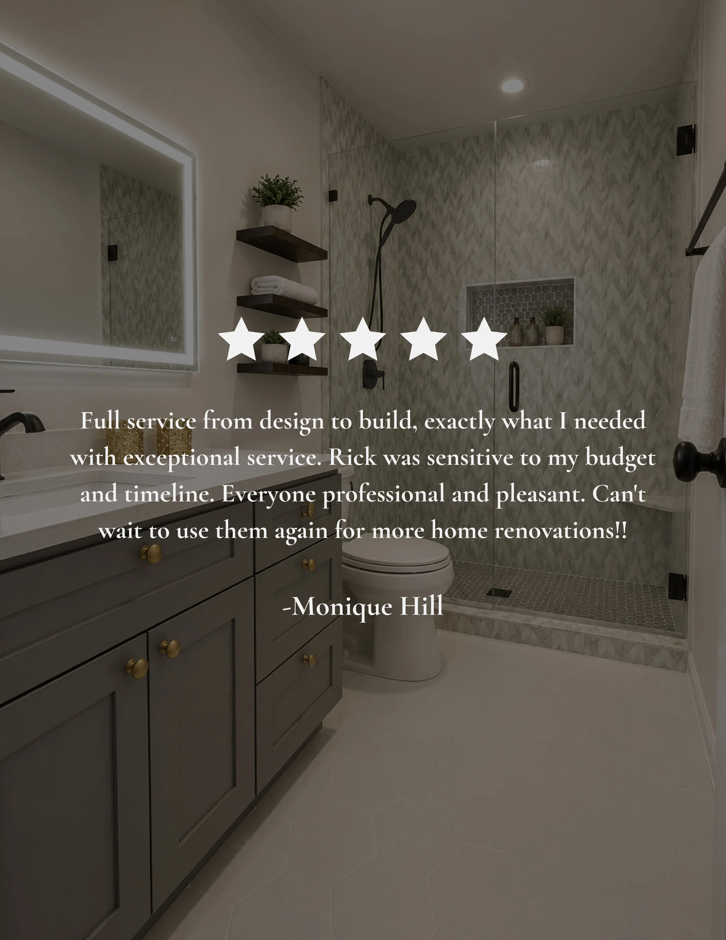 Modern bathroom with gray cabinetry, white hexagon tile floors, a large mirror with LED lighting, a glass shower with textured tile walls, a built-in shower niche with toiletries and plants, a corner shelf with towels and plants, and a towel bar on t