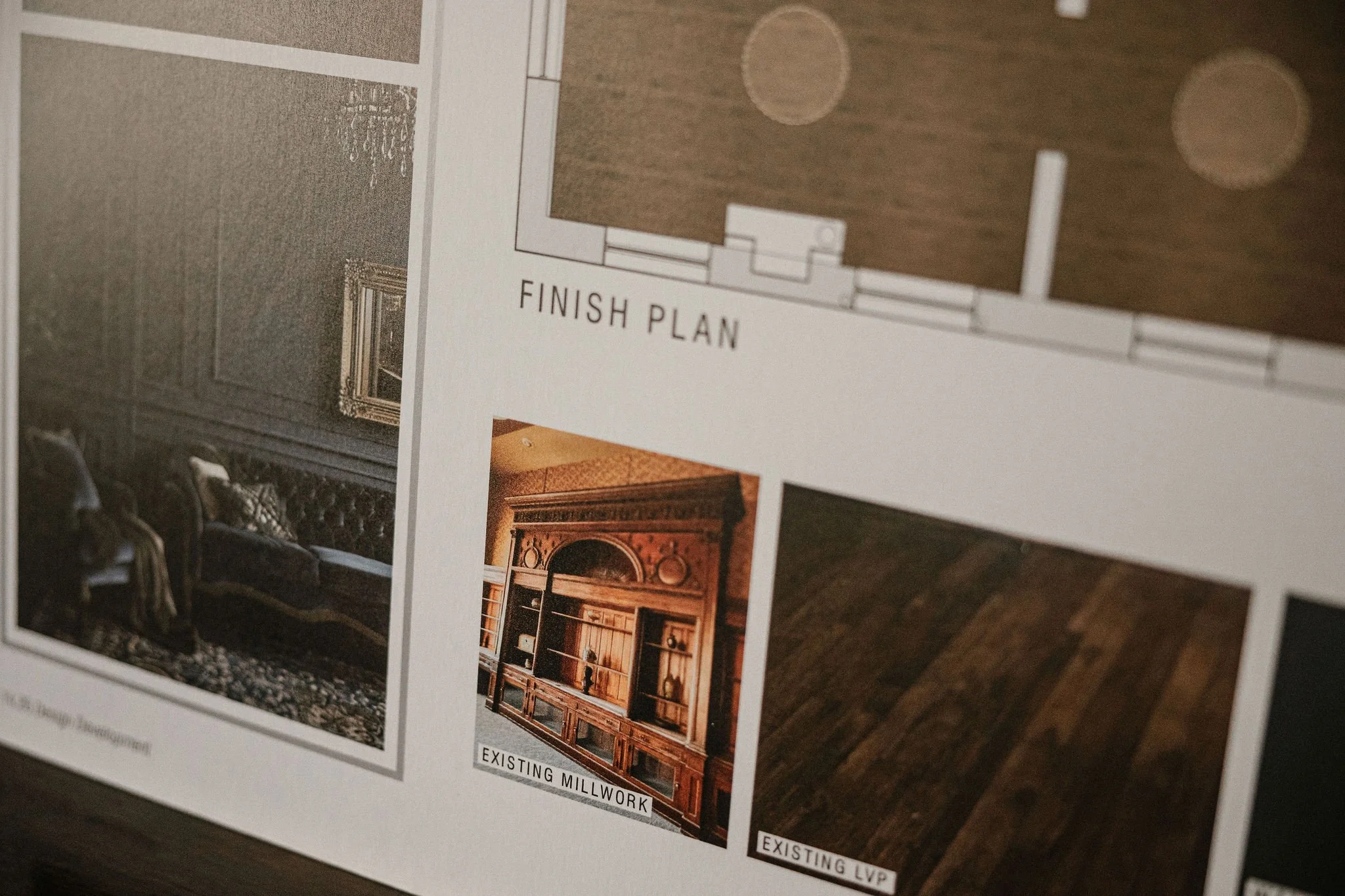 A printed interior design plan showing a bedroom with wall moldings, ornate furniture, and a chandelier.