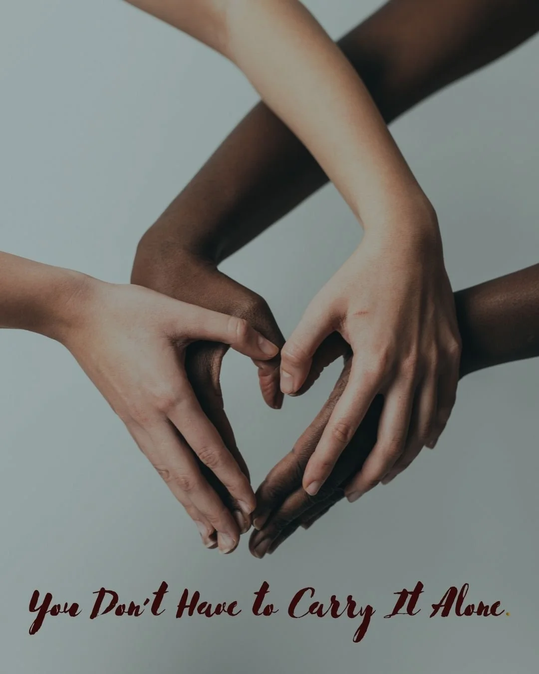Multiple hands of different skin tones forming a heart shape with a plain background and the text 'You Don't Have to Carry It Alone' at the bottom.