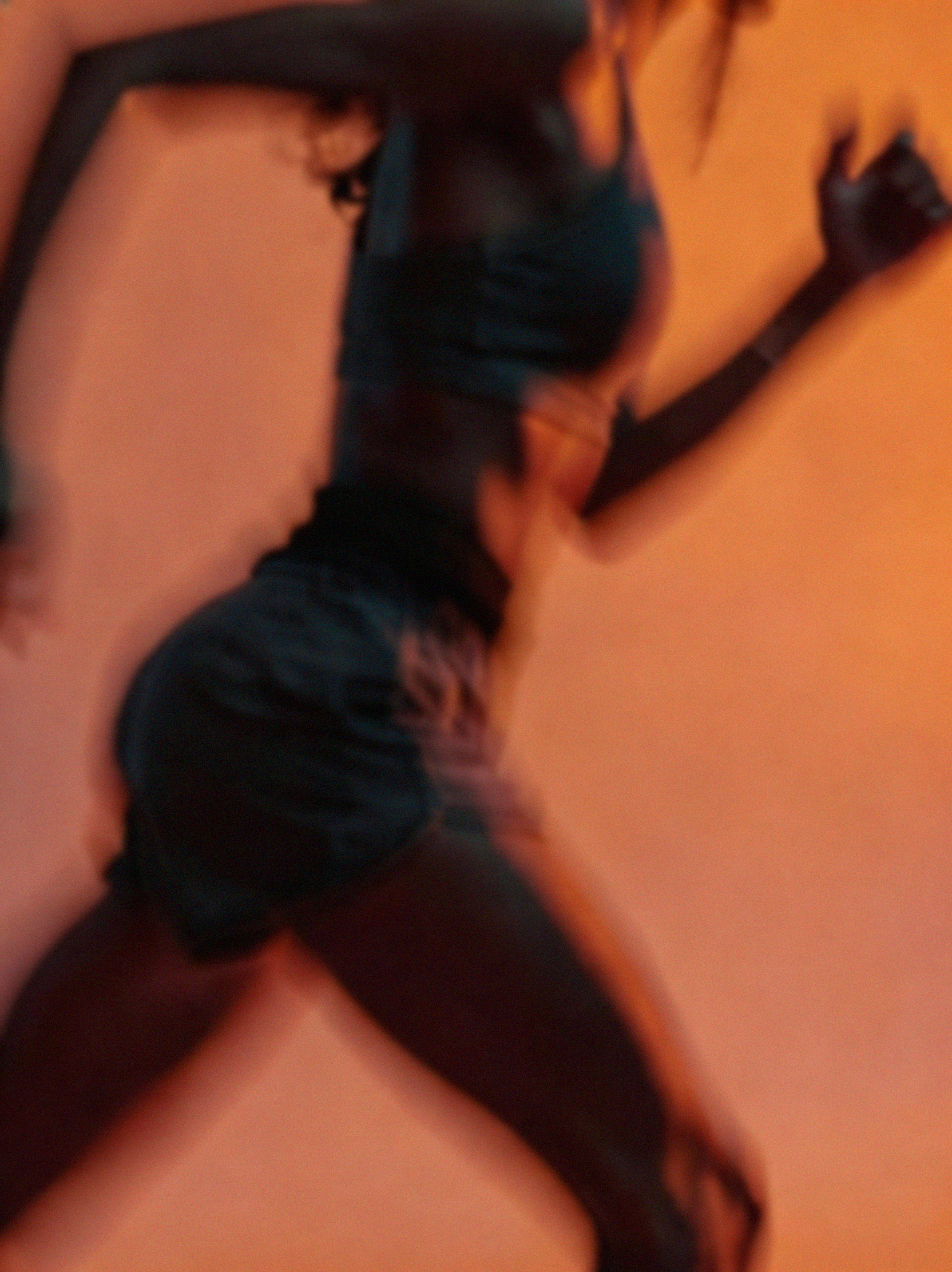 A silhouette of a woman running in orange colored lighting