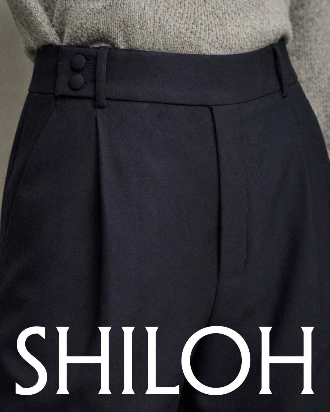 Close-up of a person wearing dark high-waisted trousers and a grey sweater, with the 'SHILOH' logo overlaid at the bottom.