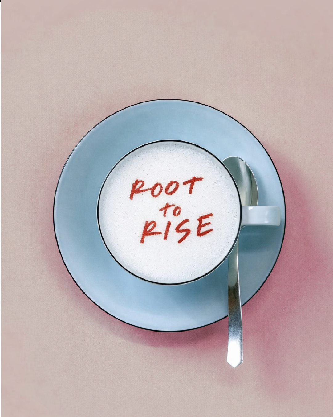 A cup of coffee on a blue saucer with the Root to Rise brand in red on top of the coffee.
