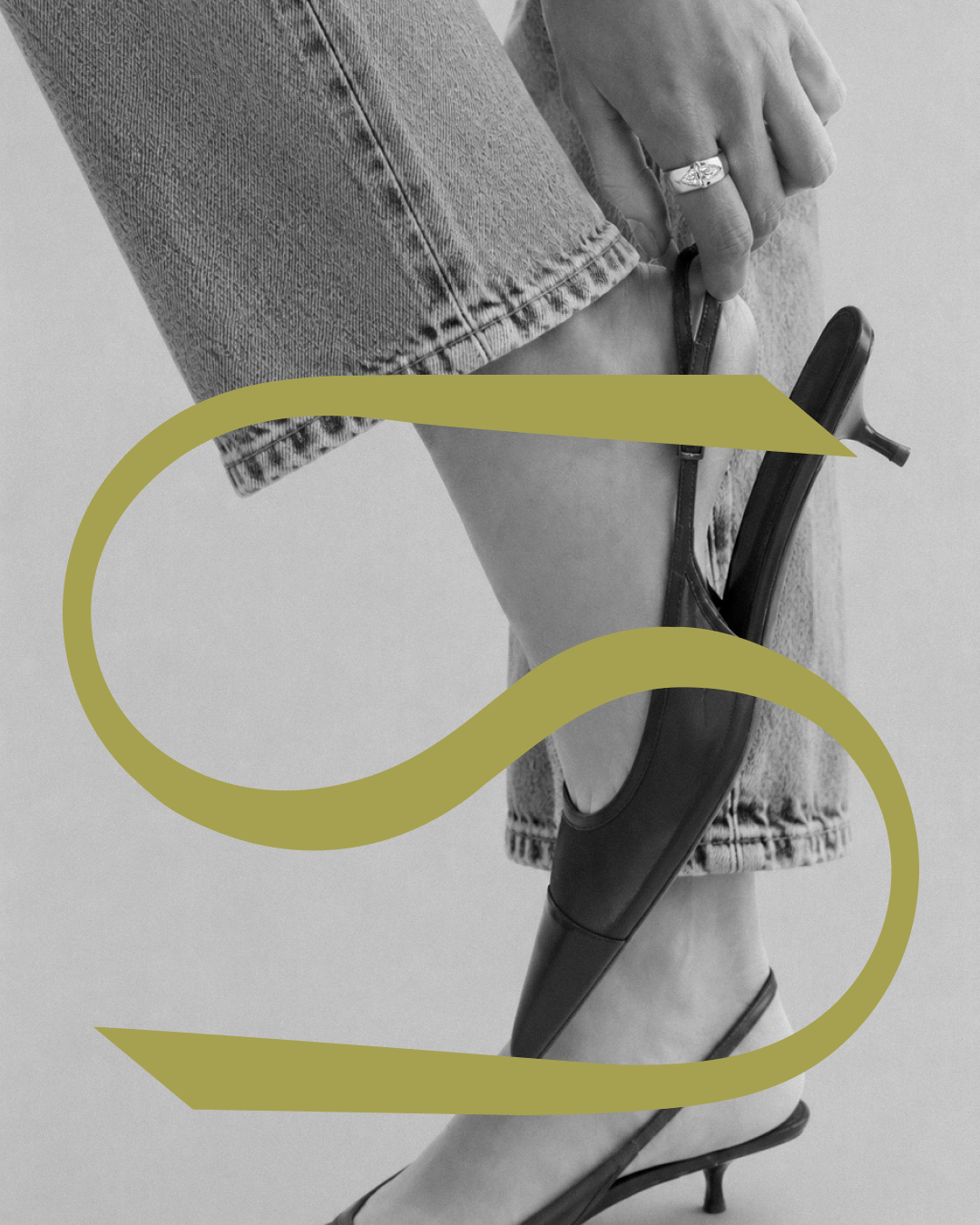 Person in denim jeans and heels adjusting her strap on her shoe with a diamond ring on her pointer finger. The chartreuse colored S brand mark for SELA is overlayed on top.