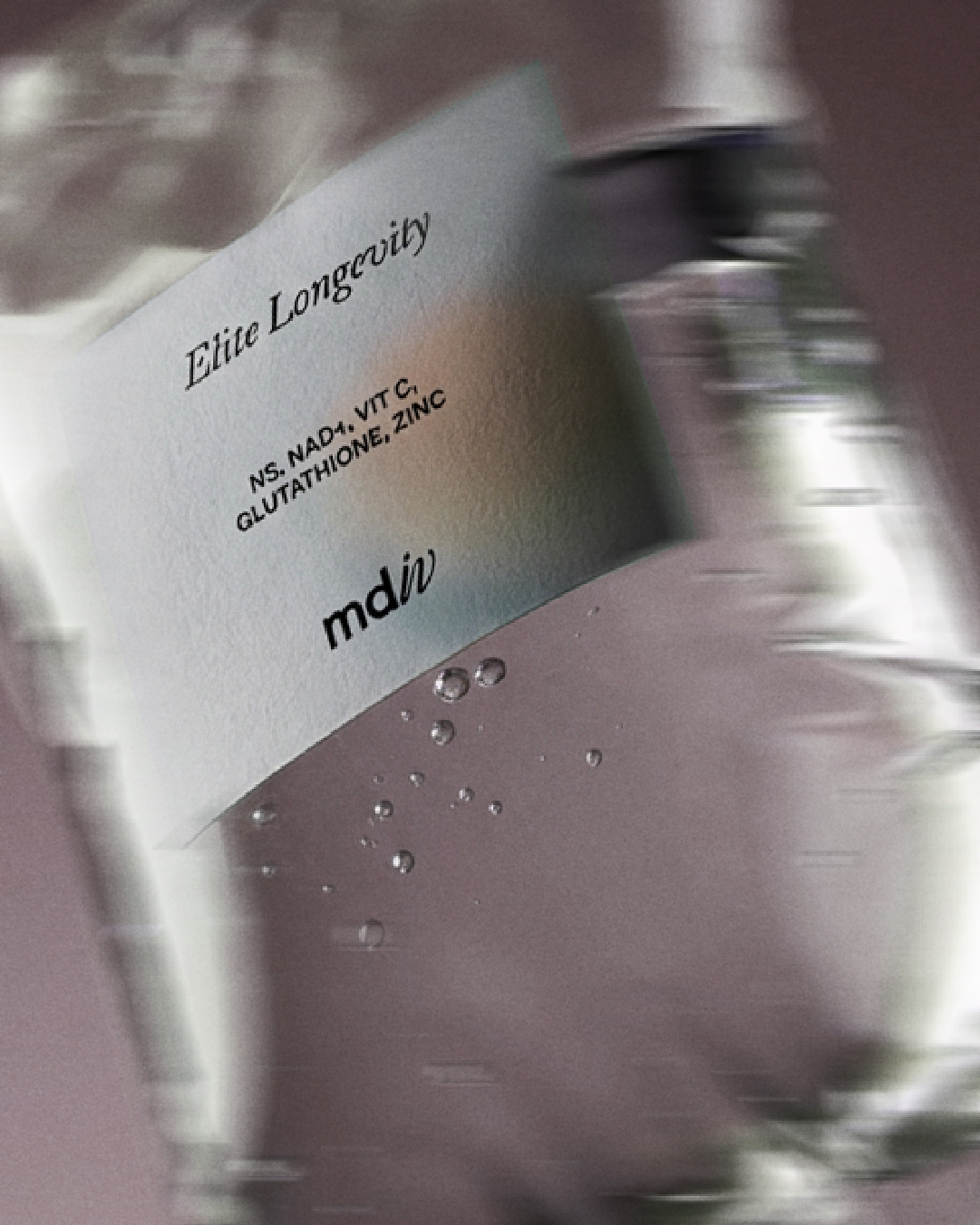 Close-up of an IV infusion label design listing ingredients like sodium NAD, vitamin C, glutathione, and zinc, with bubbles inside the bottle.