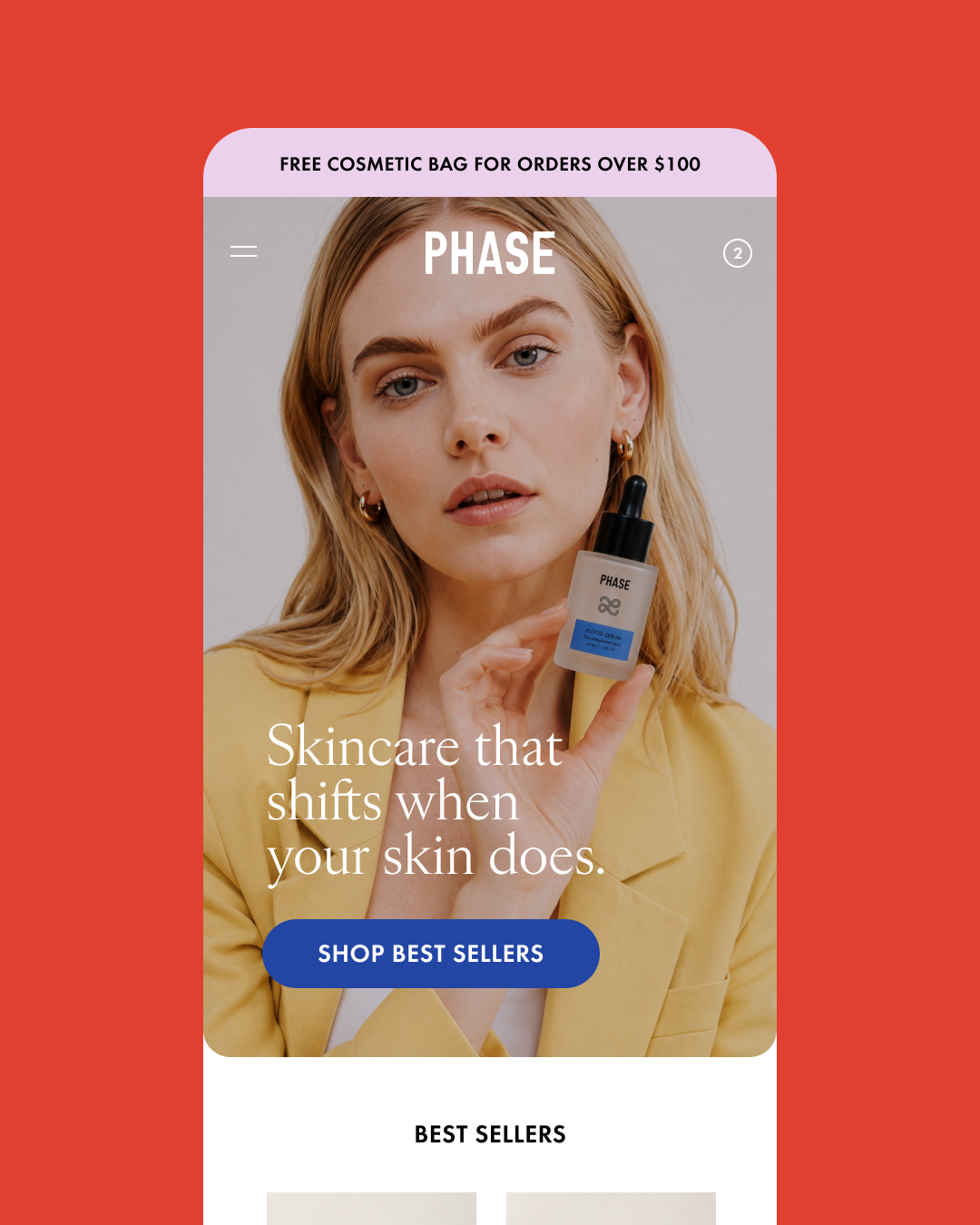 A screen grab of the mobile website for Phase skincare featuring a woman with blonde hair wearing a yellow blazer holding a skincare serum bottle, with a red background.