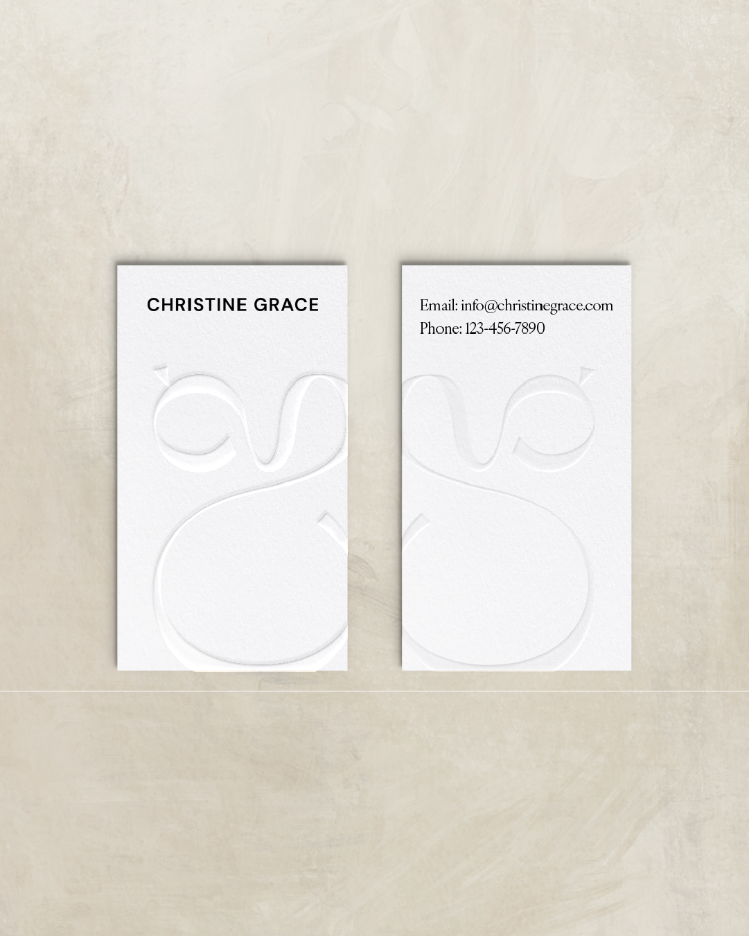 Business cards with embossed logo, one featuring the name 'Christine Grace' and the other displaying contact information including email and phone number.