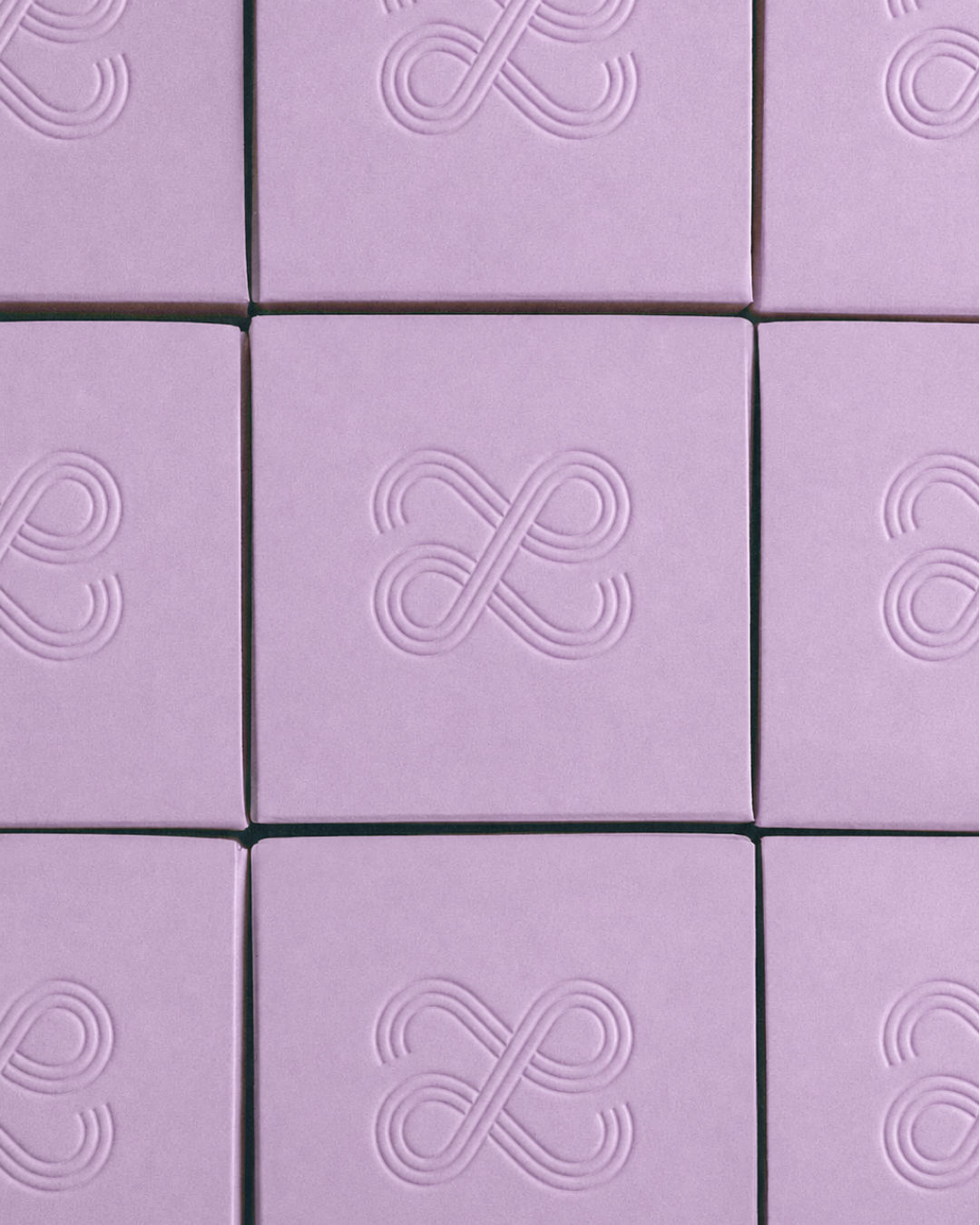 Lilac boxes with an embossed logo for Phase skincare on top.