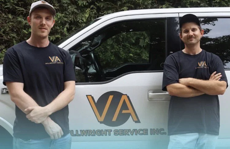Two men standing in front of a company vehicle with the logo V/A and the name Vollwright Service Inc. wearing black T-shirts with the same logo.