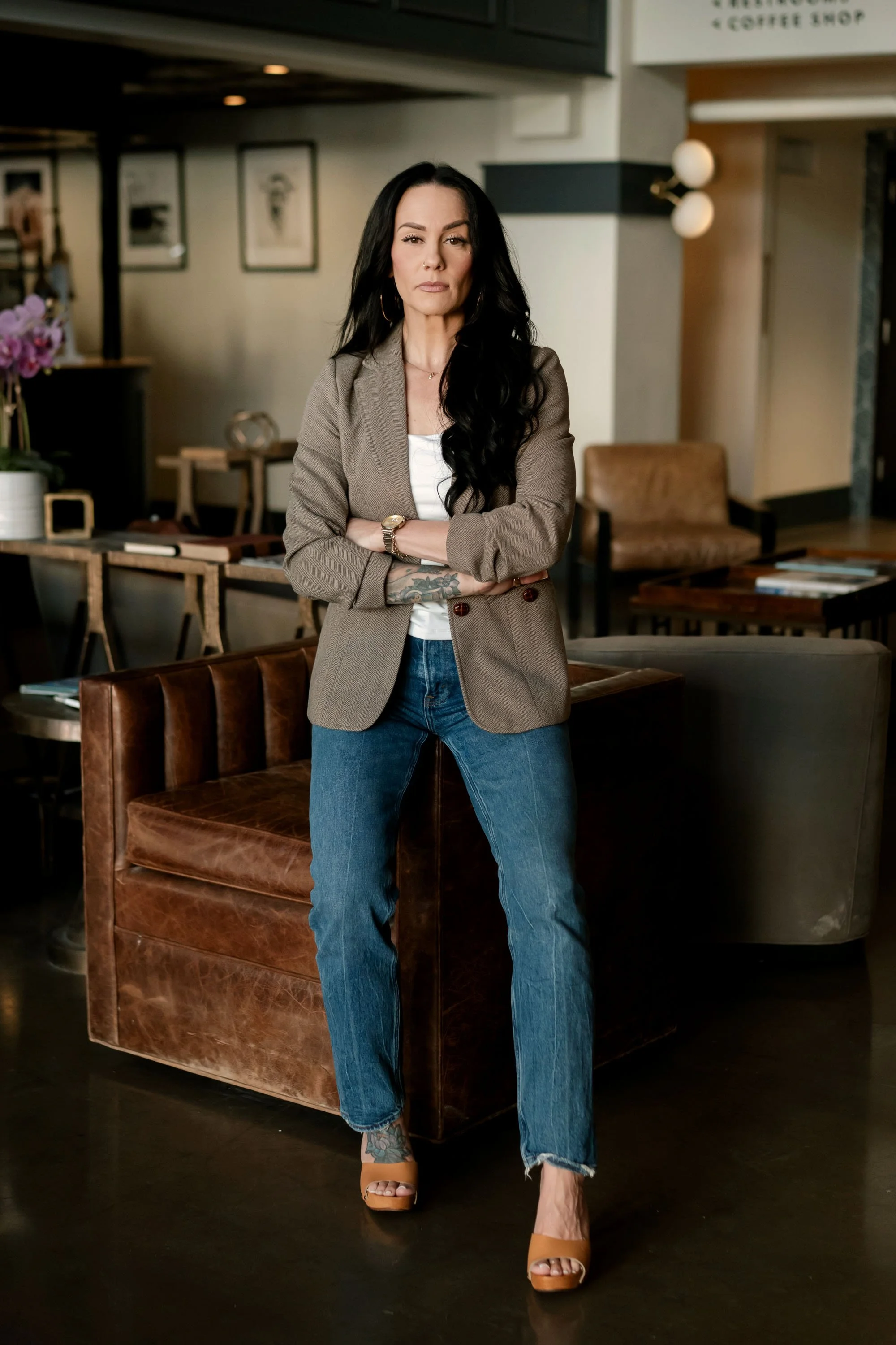 Gwen Taniguchi, business operations strategist and Certified Exit Planning Advisor, standing in a café.
