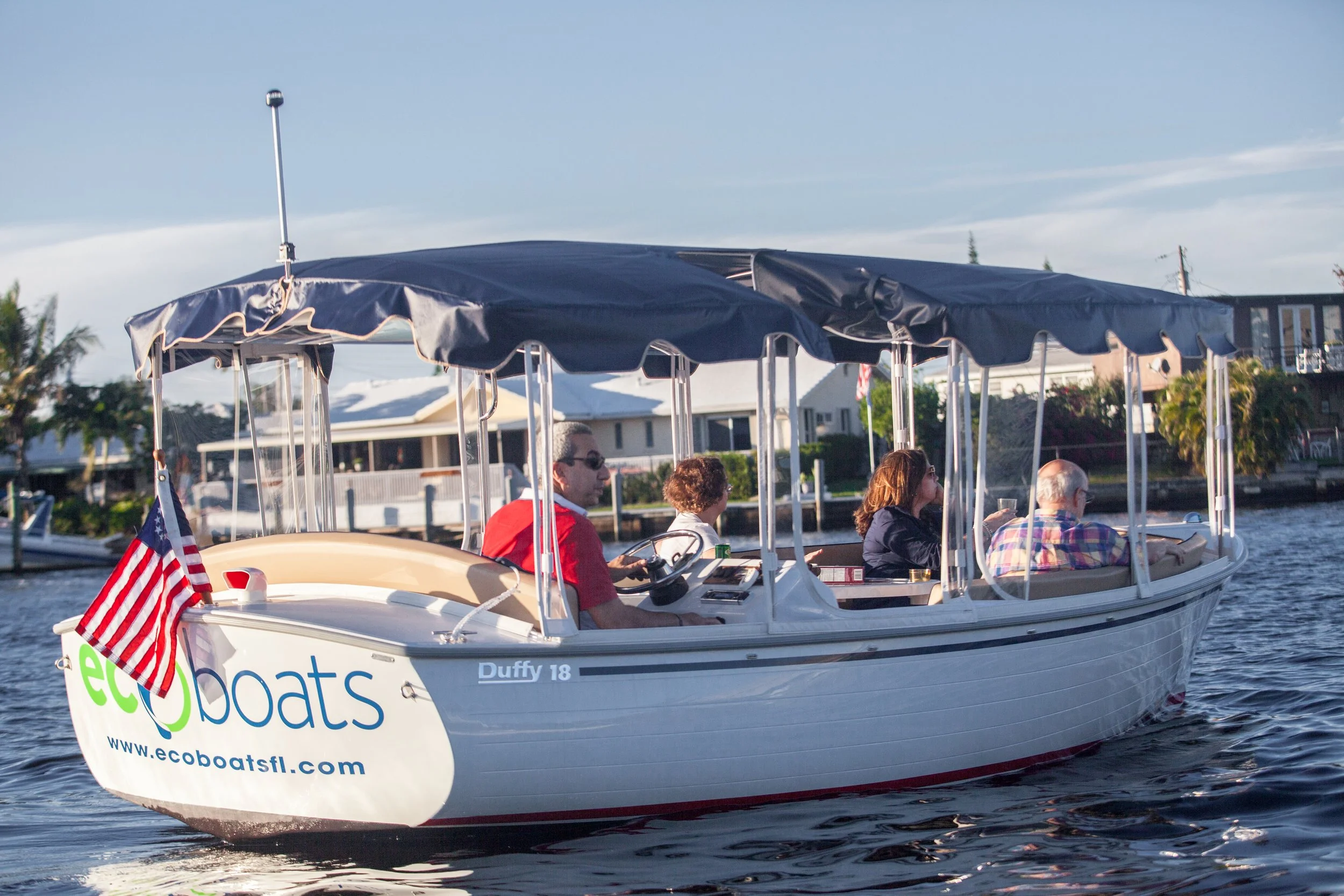 EcoBoats electric Duffy boat with canopy cruising a Fort Lauderdale waterway