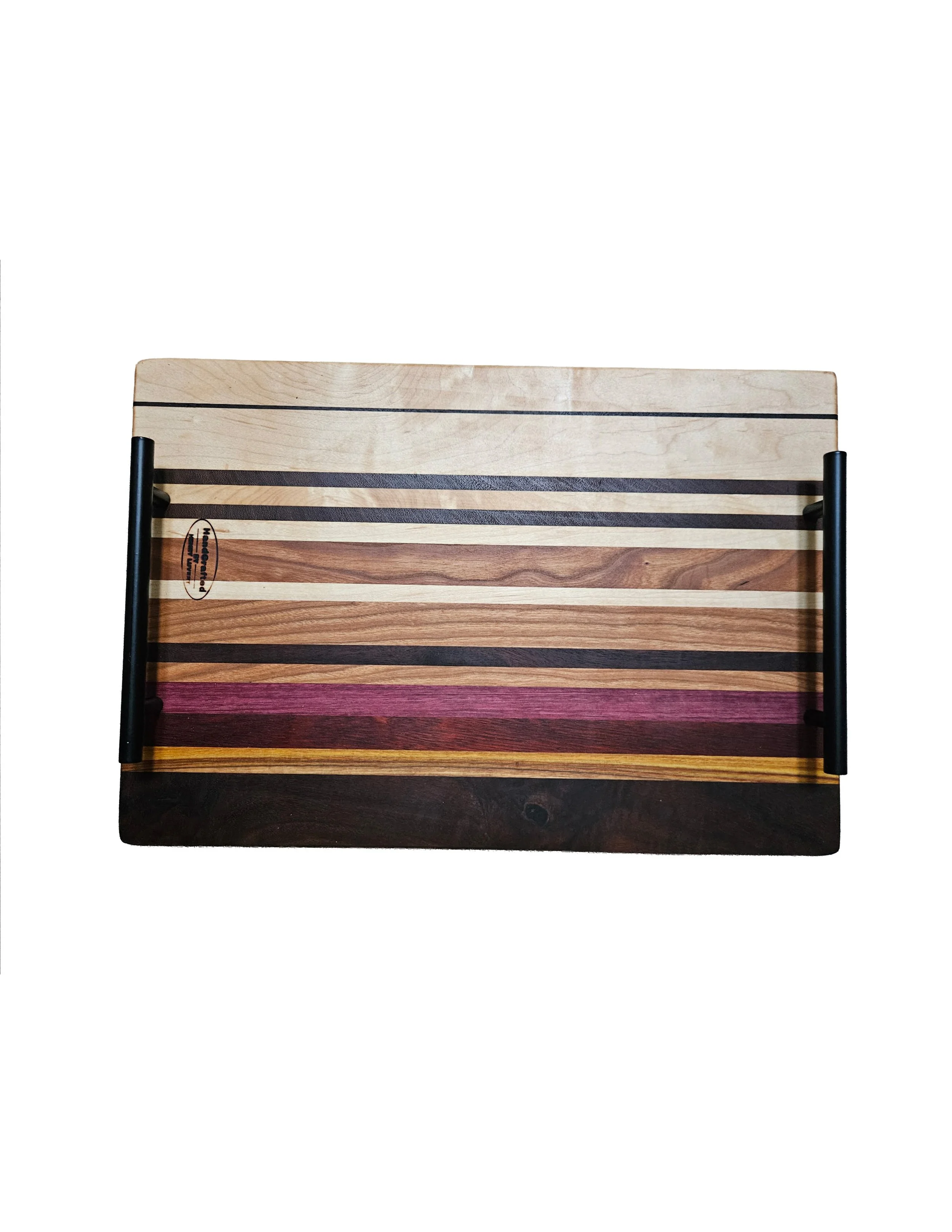 A wooden cutting board with horizontal stripes of different wood tones, framed by black metal handles on the sides, photographed against a plain white background.