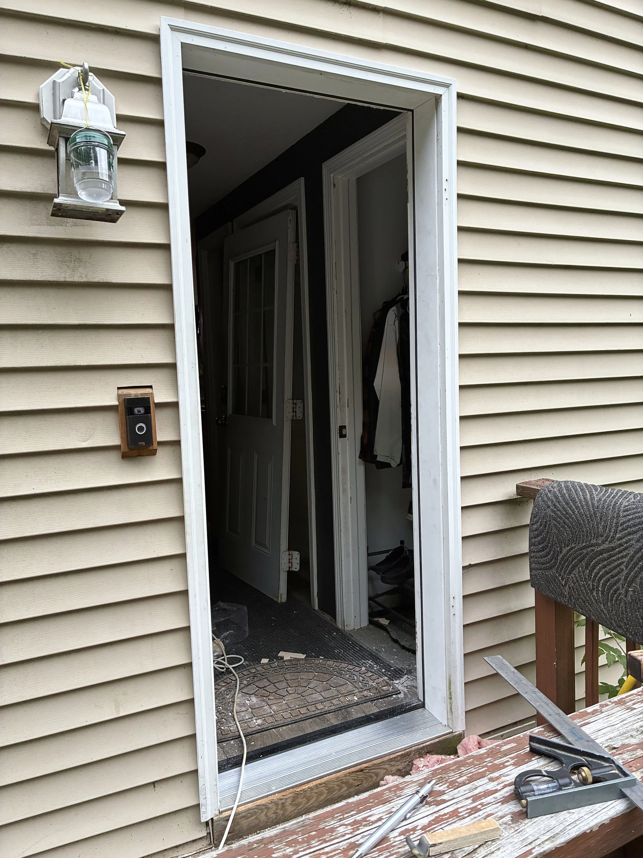 The new frame and threshold slid into place and then shimmed to the shape of the door.