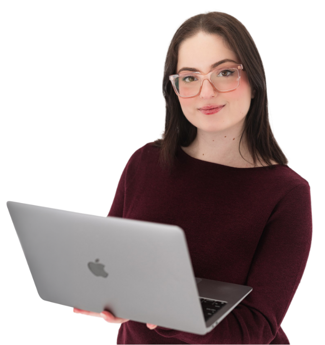 A young woman with glasses and brown hair holding a silver MacBook laptop.
