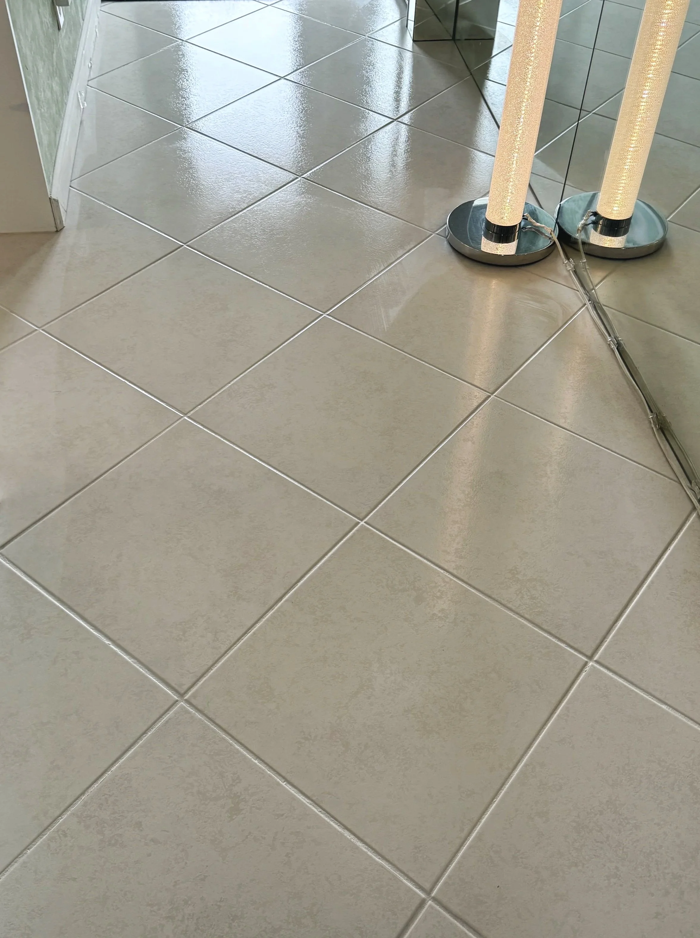 High-gloss beige ceramic tile floor after Caponi grout sealing in Fort Lauderdale.