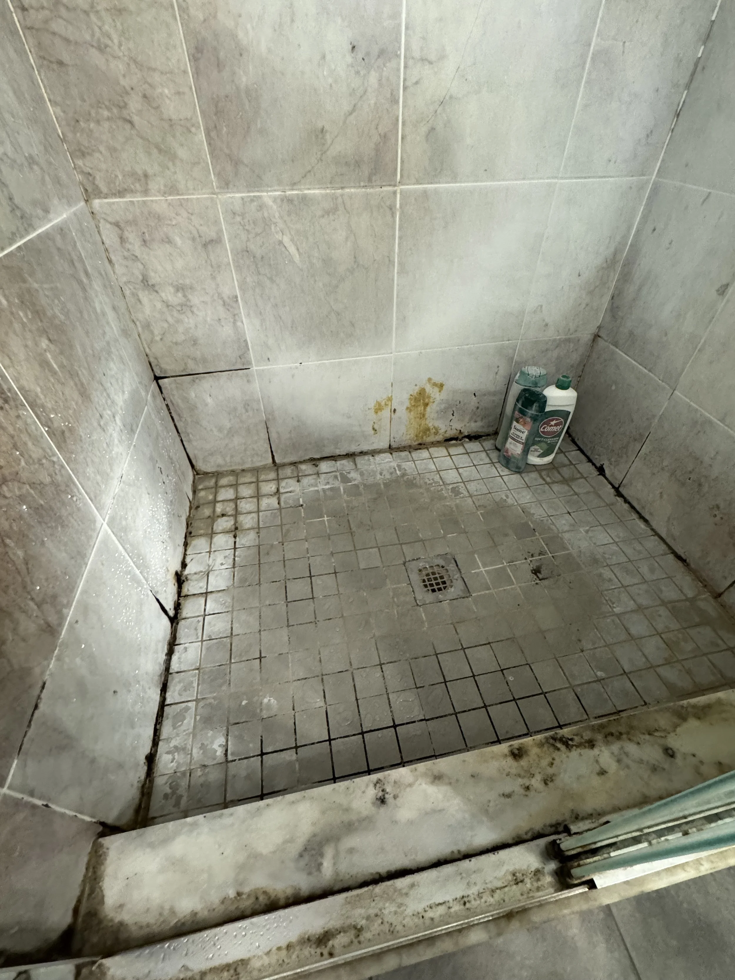 Dirty shower floor prior to mold removal and HEPA extraction in Boca Raton.