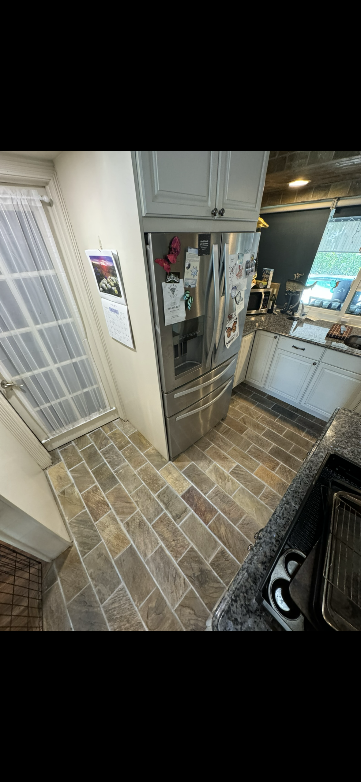 Kitchen tile flooring leading to patio after deep grout extraction in Boca Raton.