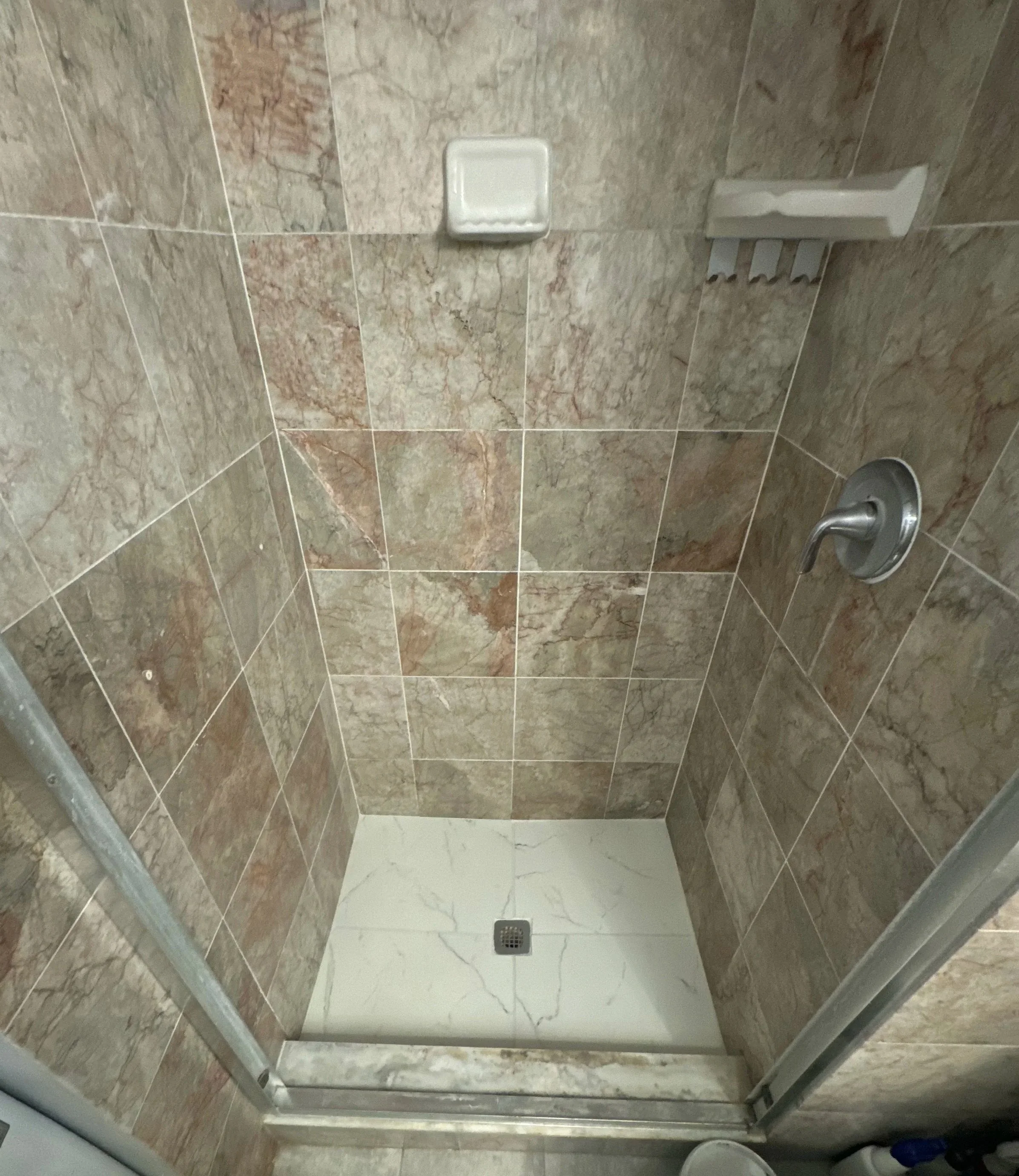 Beige and brown marble tile shower after professional color sealing, mold removal and HEPA extraction in Fort Lauderdale.