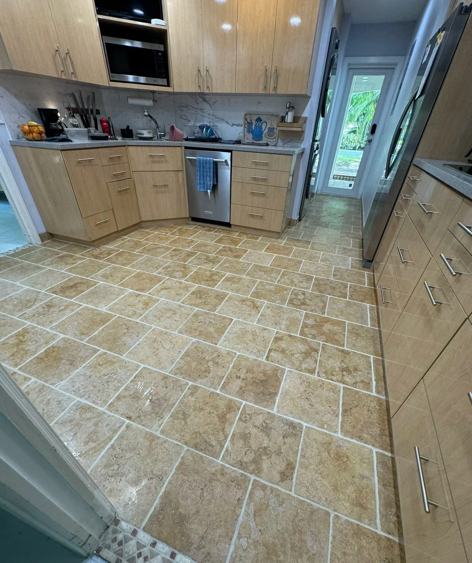 Clean tile kitchen floor after professional grout restoration in Fort Lauderdale.