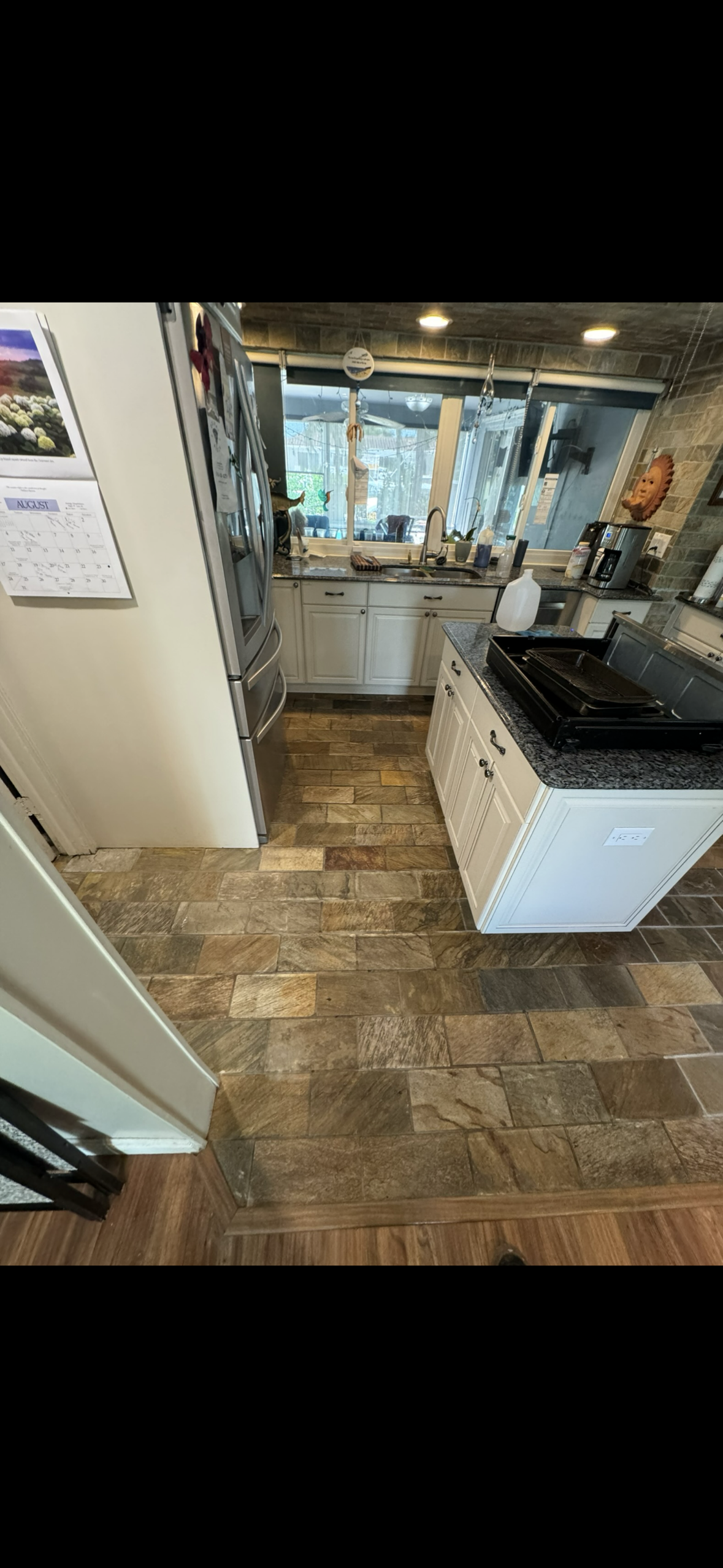 Wood-look tile kitchen floor professionally restored and sealed in Coral Springs.