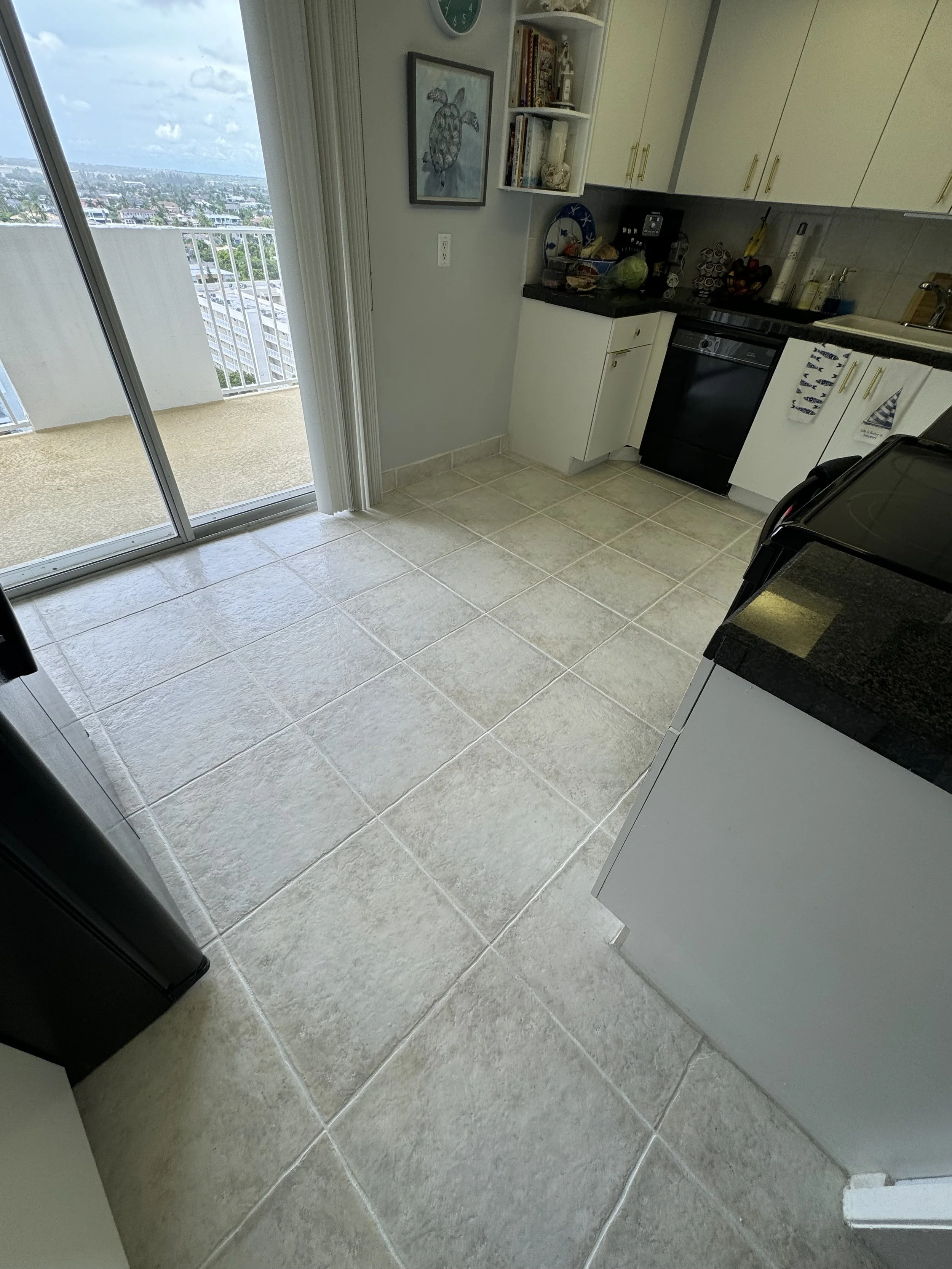 Kitchen tile floor professionally cleaned and color sealed in Coral Springs.