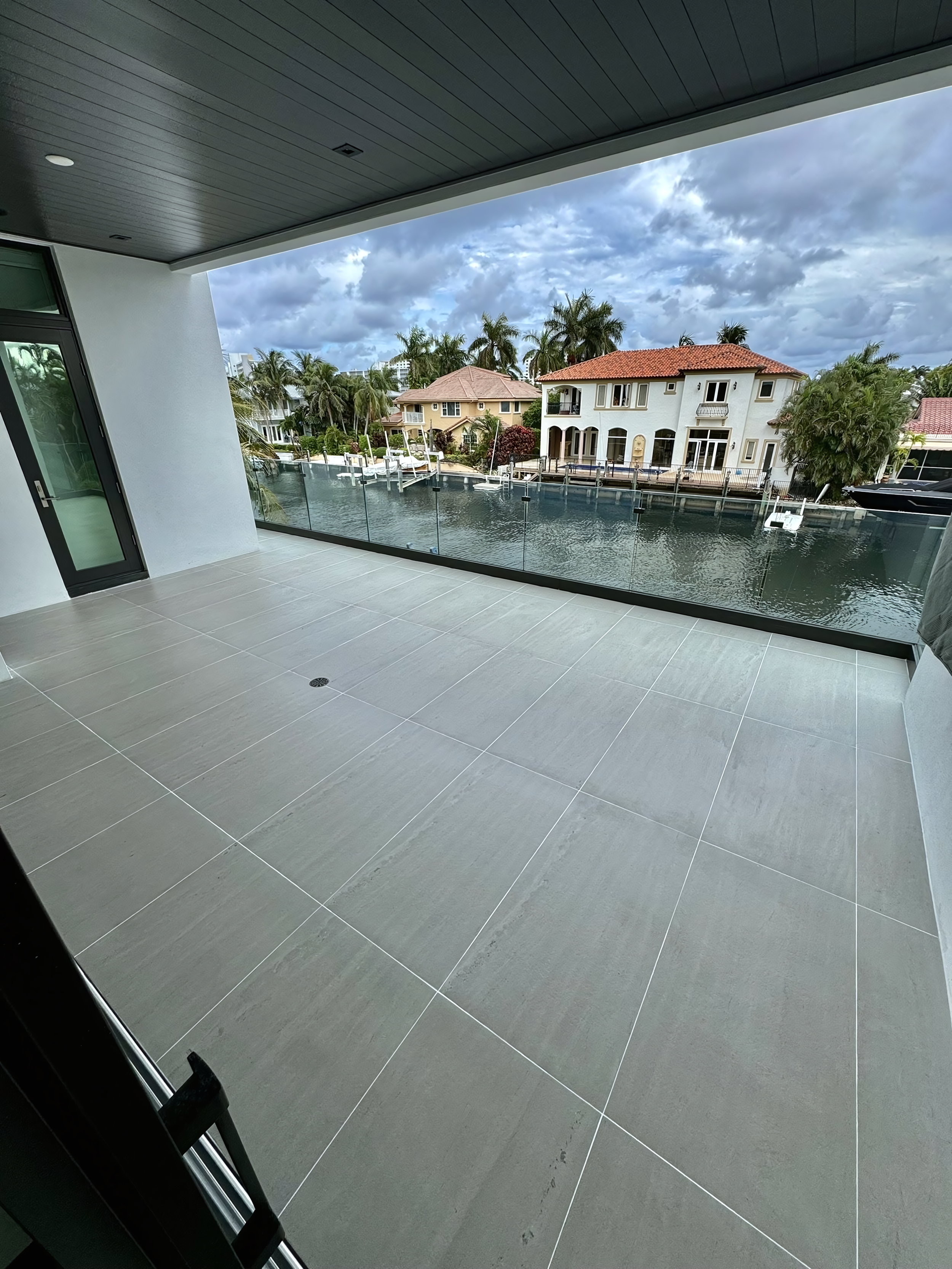 Grey tile balcony floor waterproofed and color sealed in Fort Lauderdale.