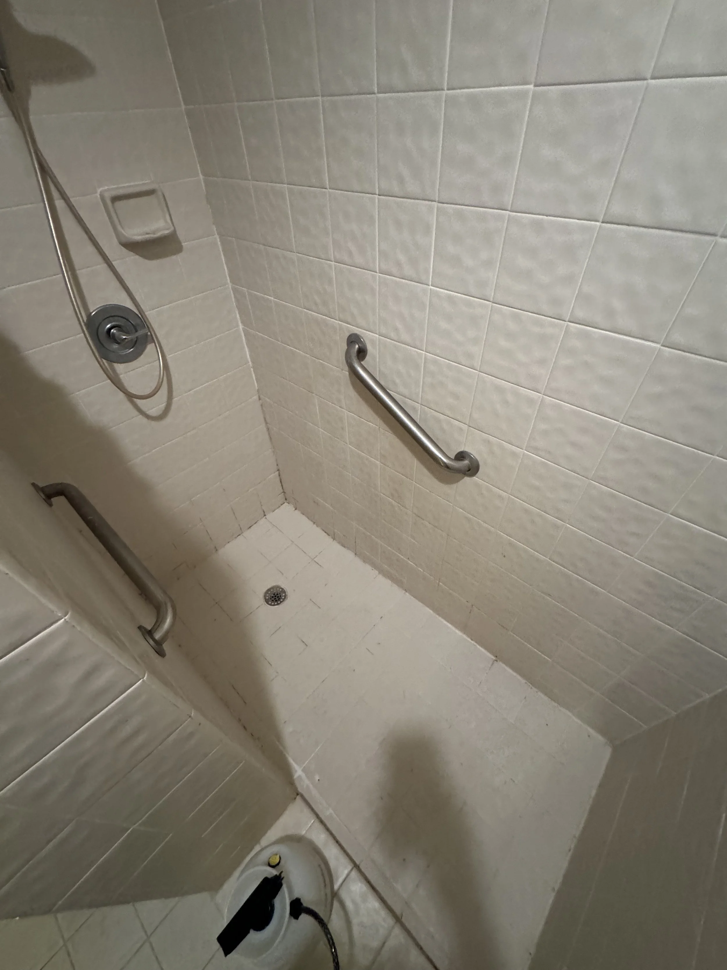 Beige tile shower wall restoration featuring Litokol structural caulking in Boca Raton.