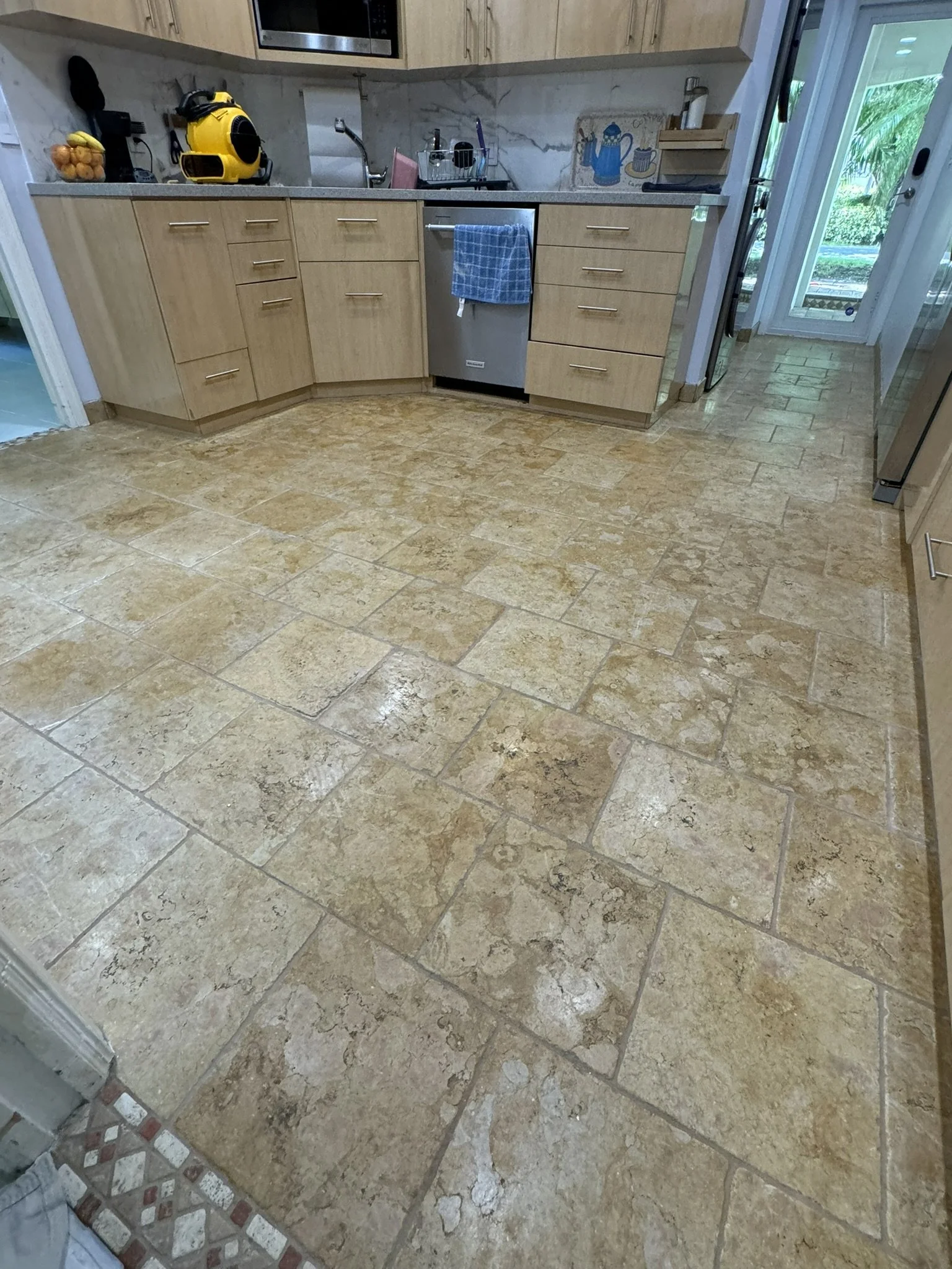 Beige tile kitchen floor restored with Caponi epoxy color sealing in Boca Raton.