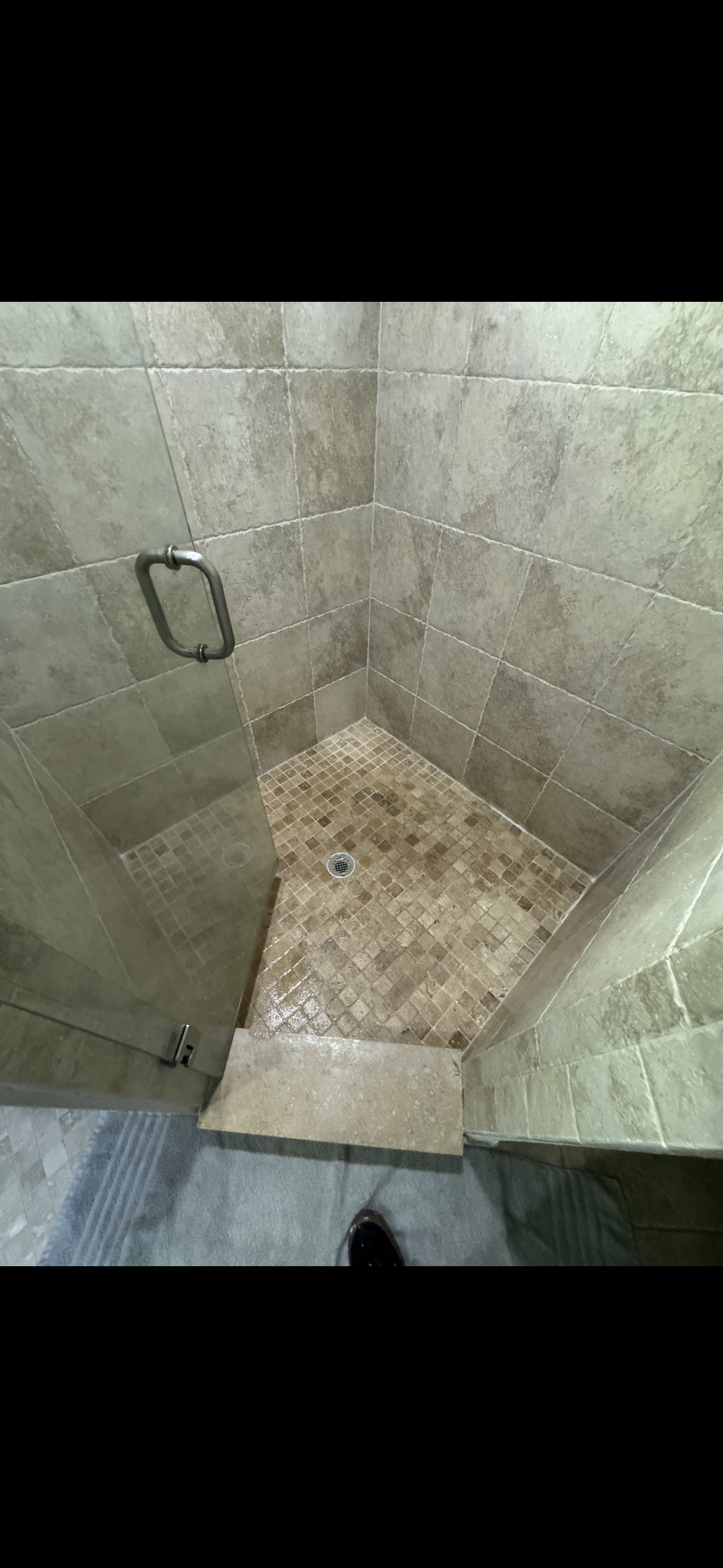 Restored shower stall with brown mosaic tile floor and waterproof grout in Boca Raton.