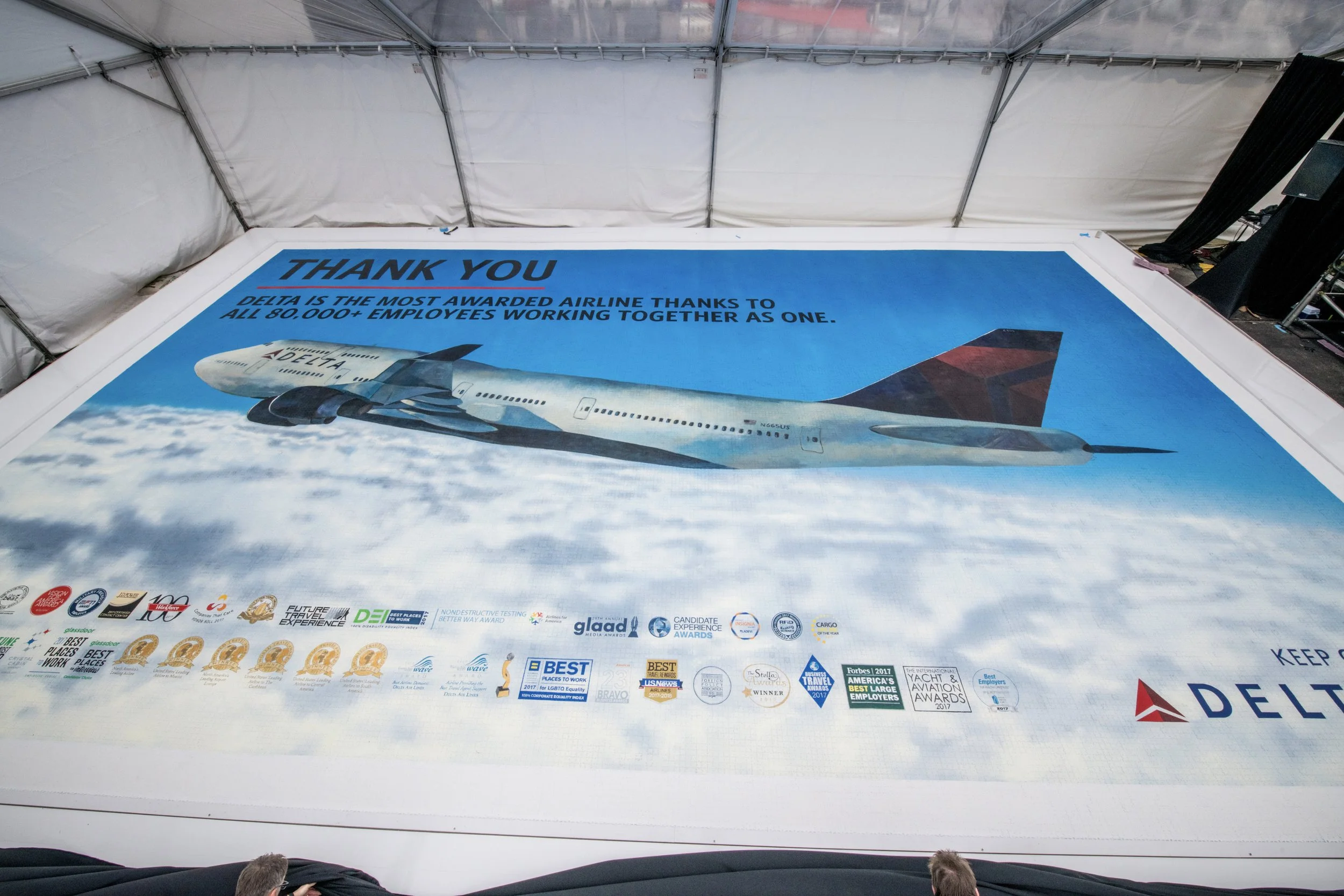 Large banner with a Delta airplane image and social media and awards logos, including the text 'Thank You Delta is the most awarded airline thanks to all 80,000+ employees working together as one'.