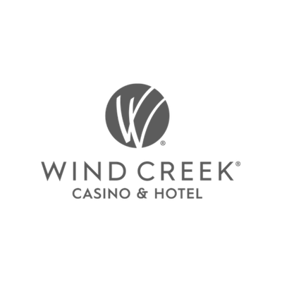 Logo of Wind Creek Casino & Hotel featuring a stylized circular design with curved lines.