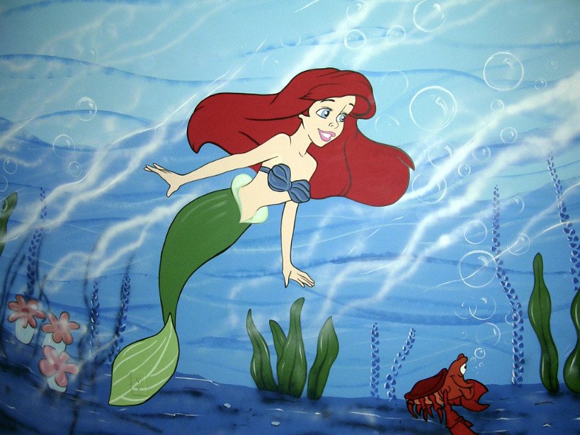 Animated scene of Ariel, the mermaid from Disney's "The Little Mermaid," swimming underwater with seaweed, flowers, bubbles, and a small crab nearby.
