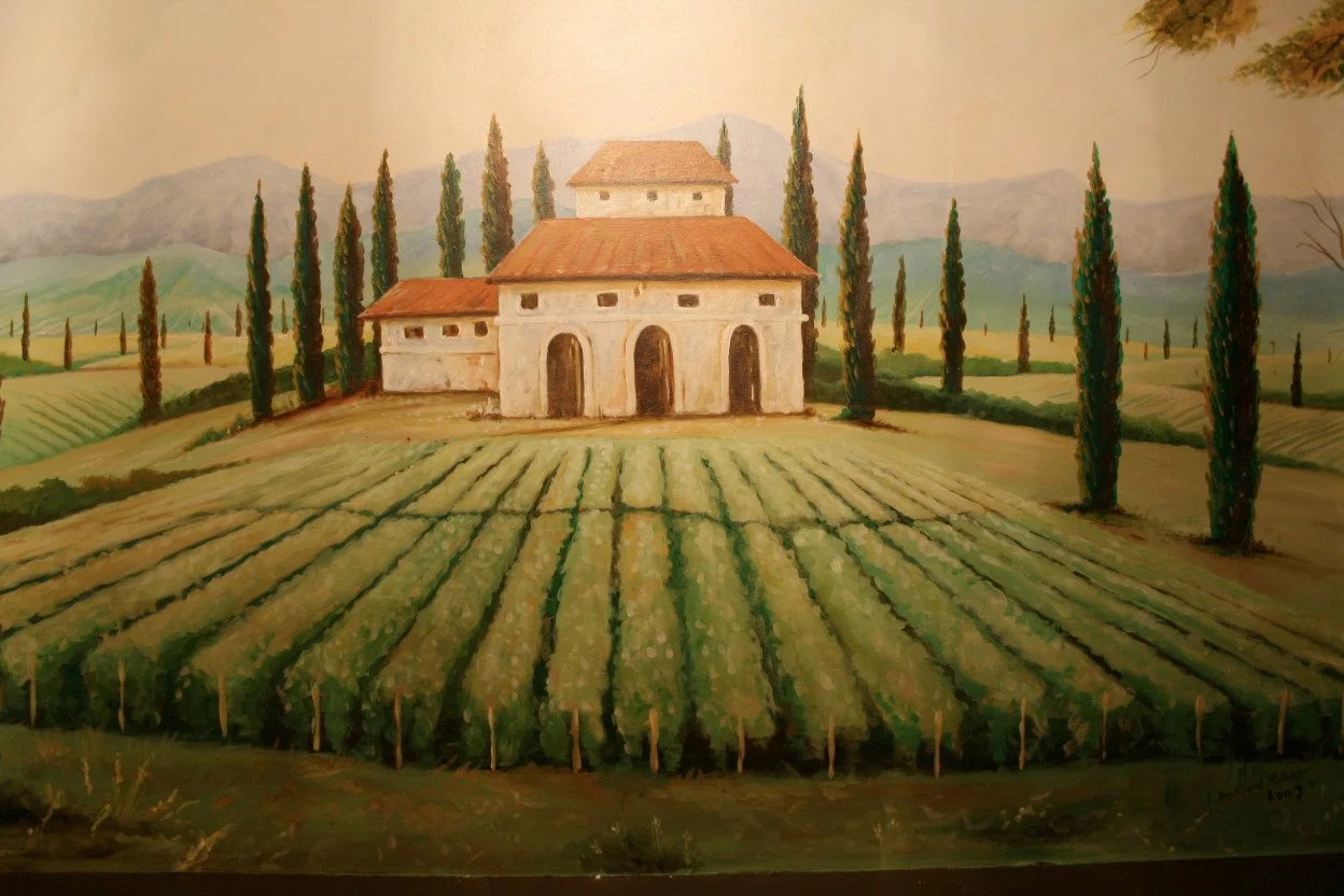 A painting of a countryside scene with a large white building with a red roof, surrounded by tall cypress trees and green fields with rows of crops.