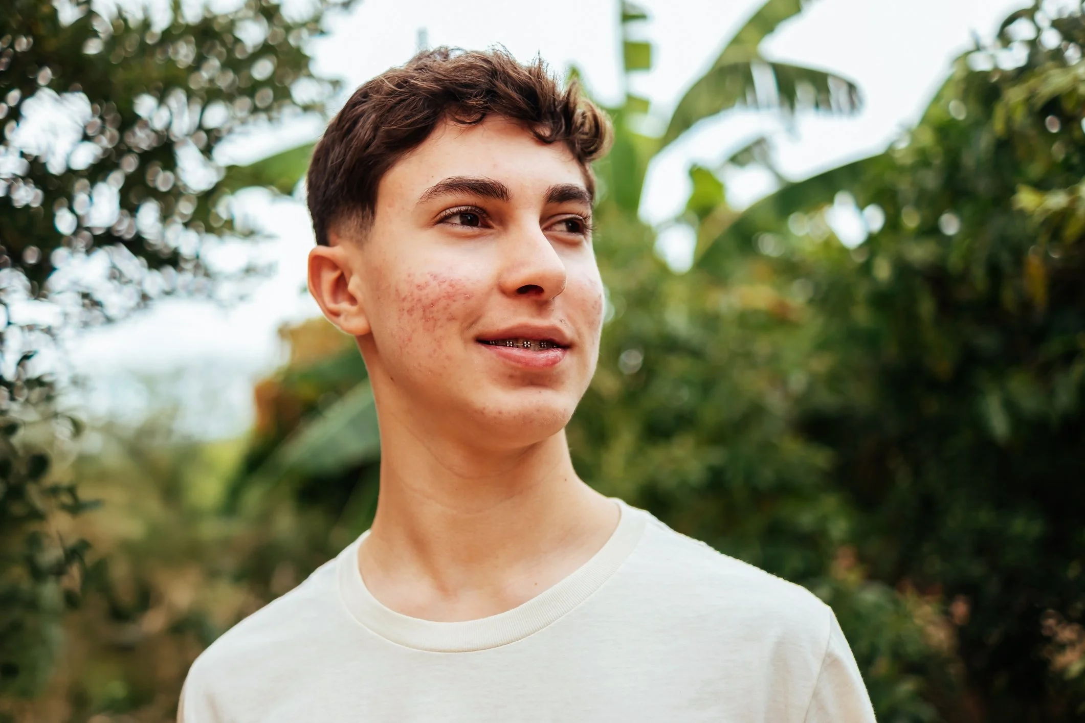 A young man sitting outdoors