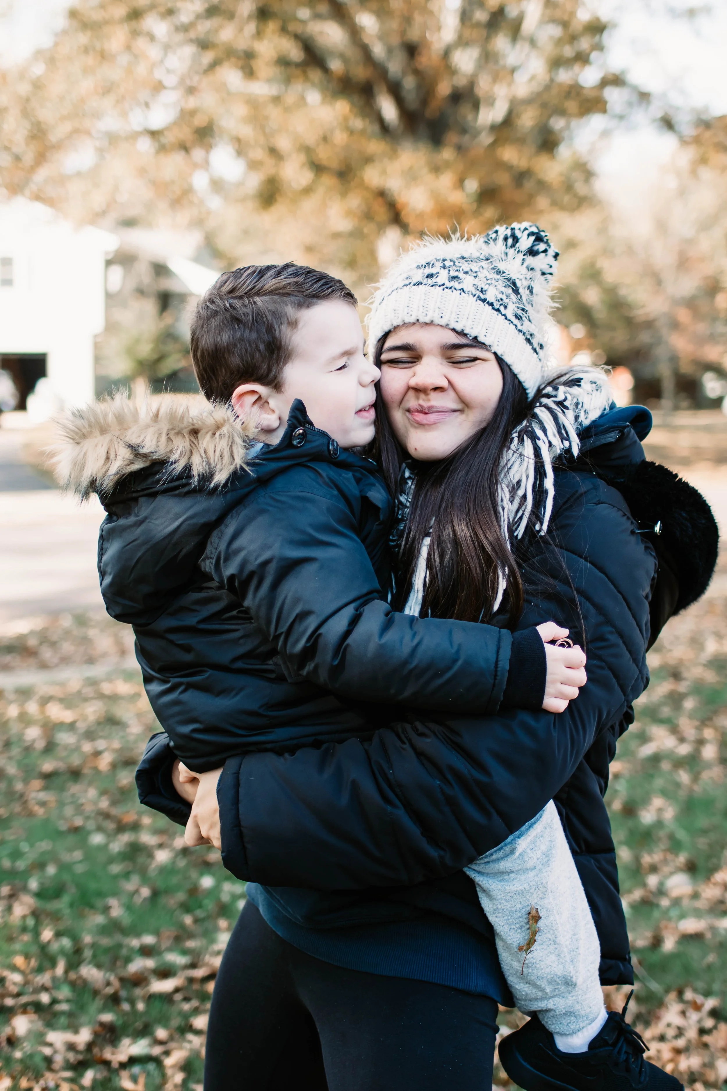 Mother and son sharing a hug during an outdoor family photography session